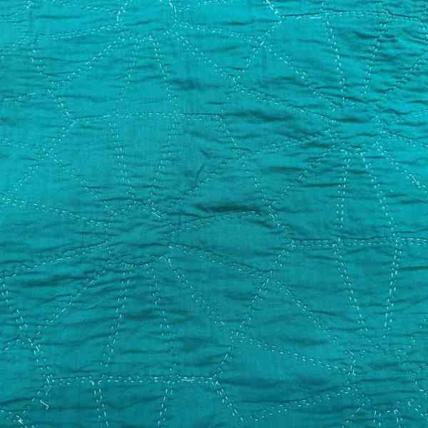 backing of the quilt that shows the quilting really well.