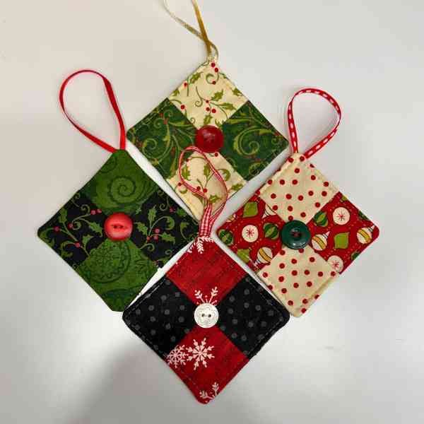 Four fabric ornaments with buttons in the middle