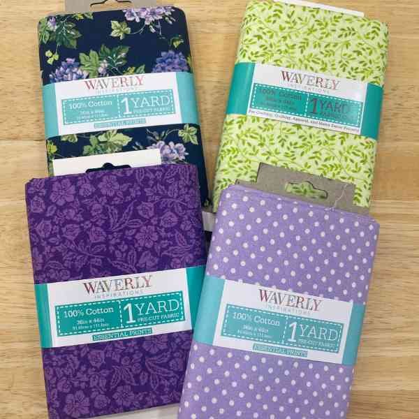 four coordinating pre-packaged fabric from Walmart. Three purple fabrics and a green fabric