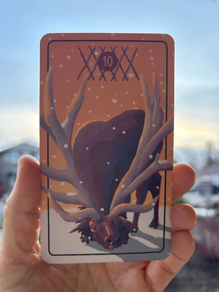 A Rocky Mountain Elk weighed down by the burden of their own antlers in The Pacific Northwest Tarot