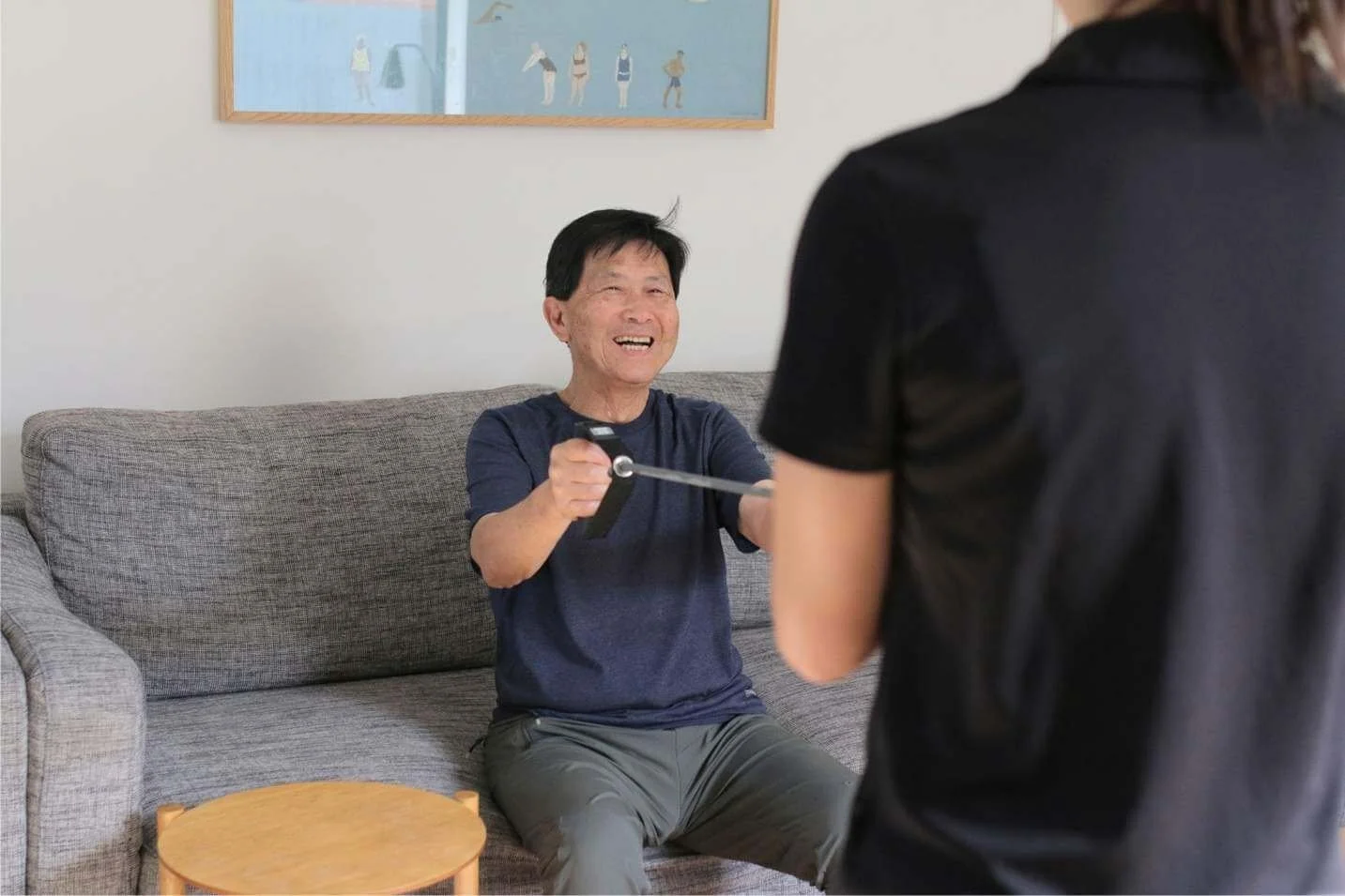 Aged care client smiling at home during physiotherapy session