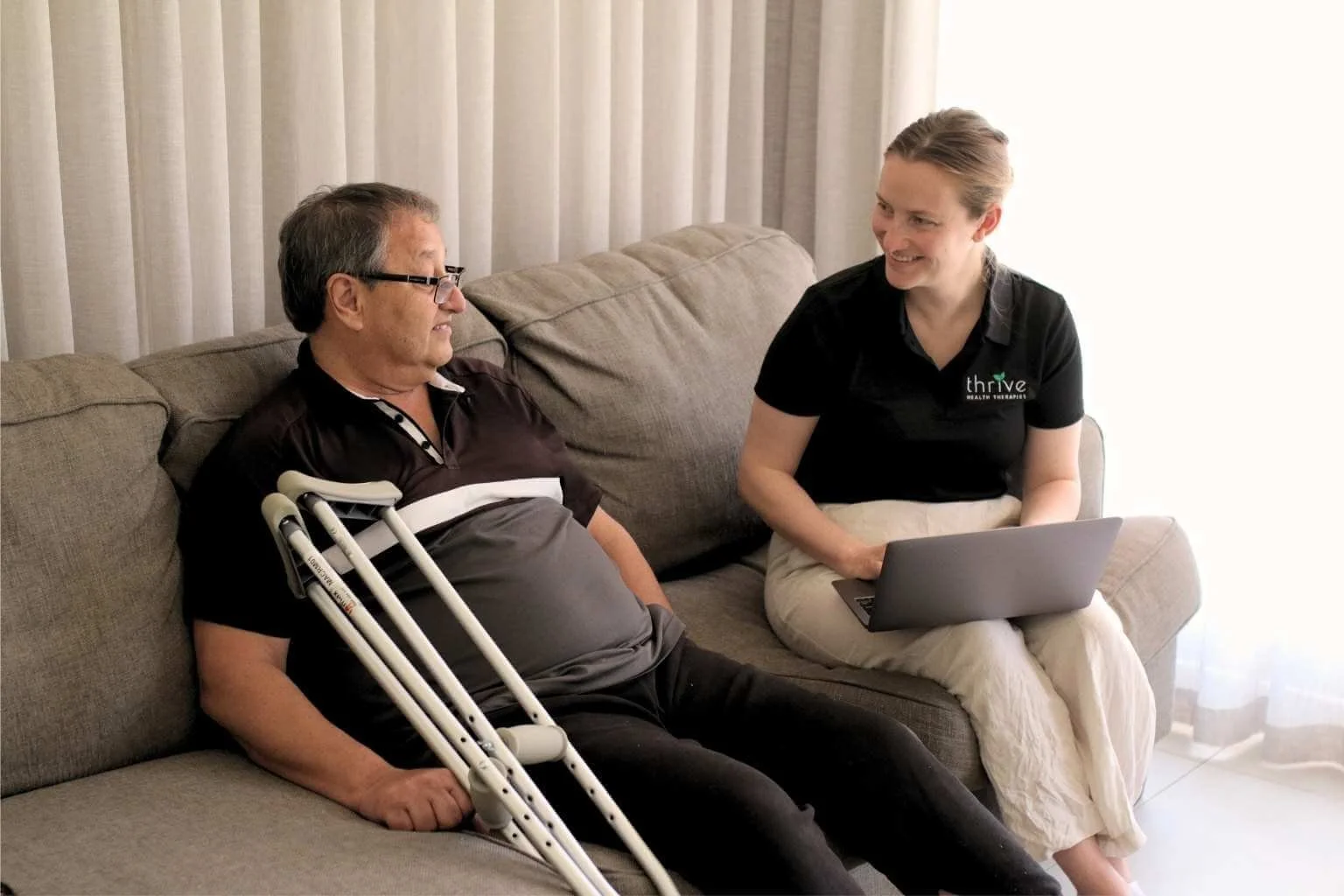 Occupational therapist and client reviewing home modification plans