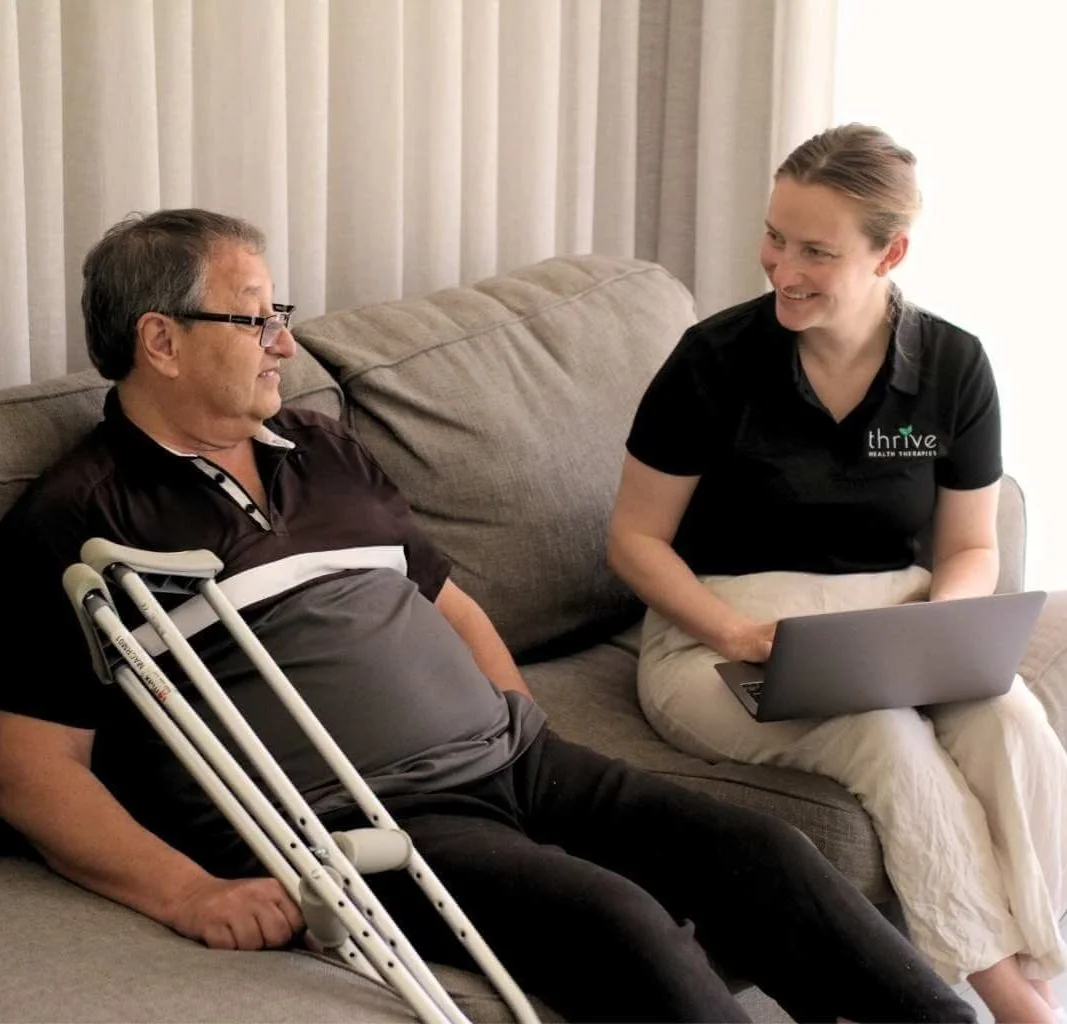 Occupational therapist and client sitting on couch during a home visit in the Adelaide Hills