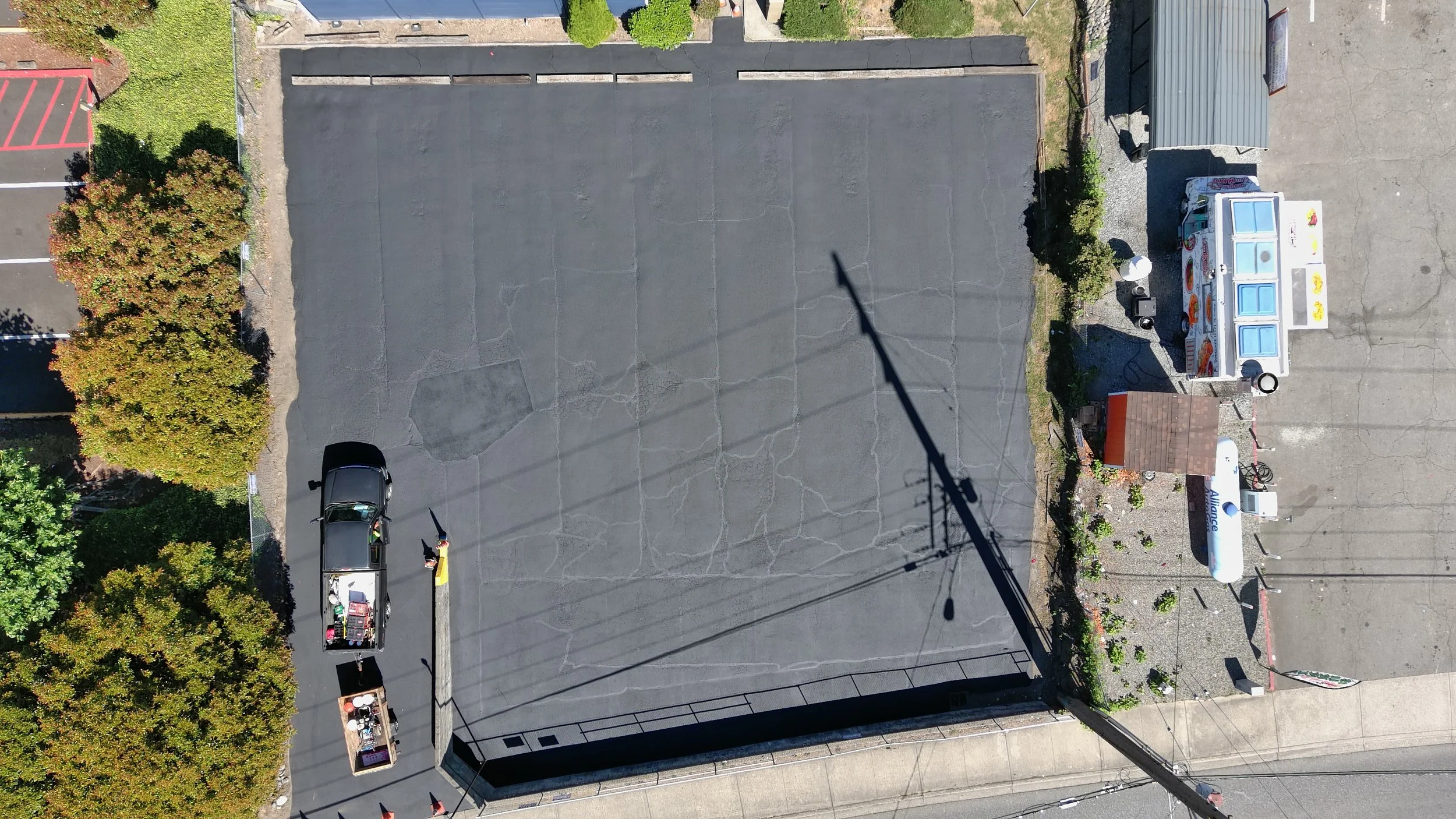Next, we sealcoat the entire parking lot to protect it from water, oil, UV rays, and weather damage. Sealcoating not only extends the life of your asphalt but also enhances its appearance with a clean, black finish. 