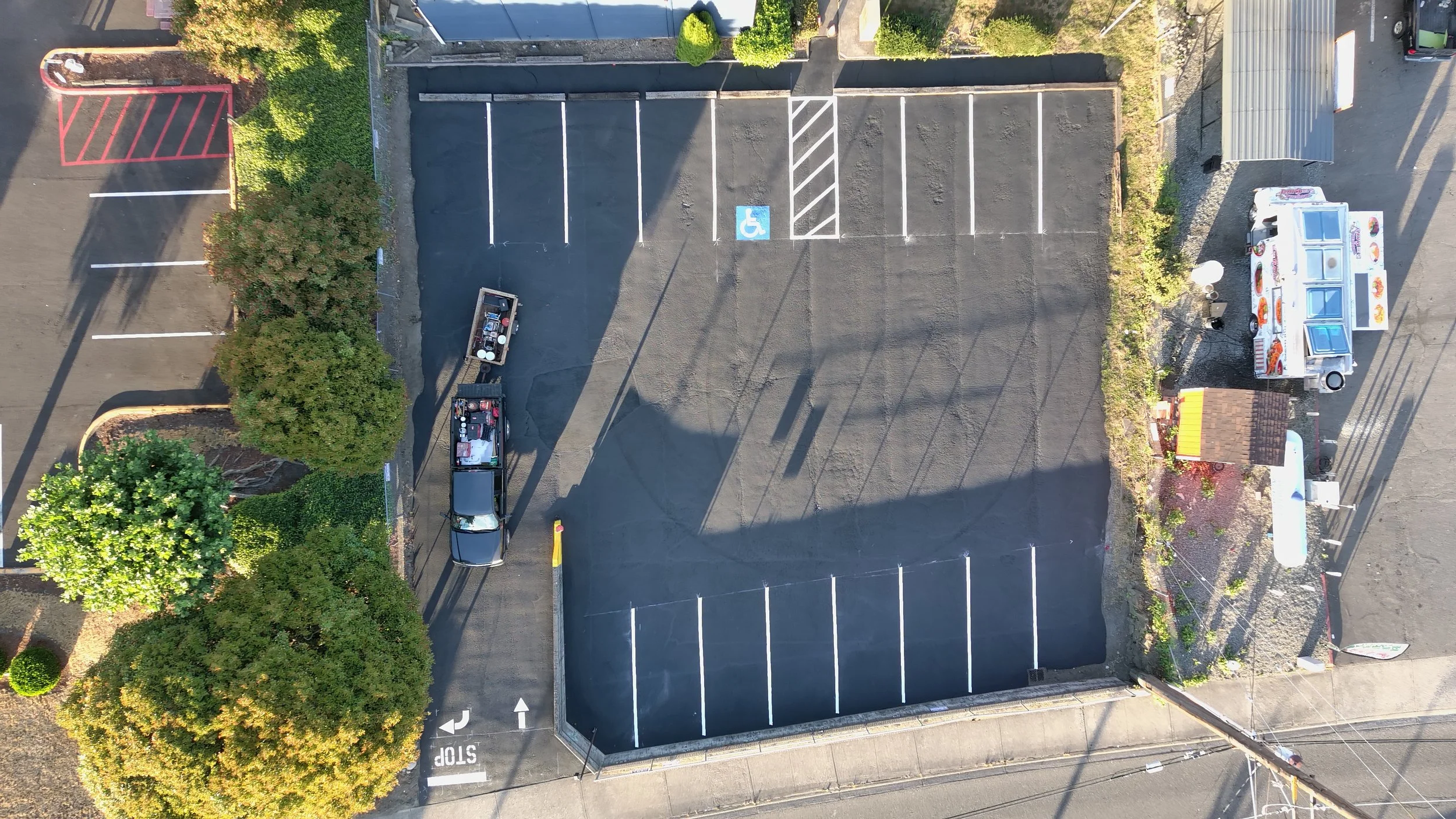 Finally, we complete the layout process by carefully measuring the lot to ensure accurate line spacing and maximize parking efficiency. If needed, we make adjustments to correct any uneven areas. We use temporary white chalk to outline the layout, wh