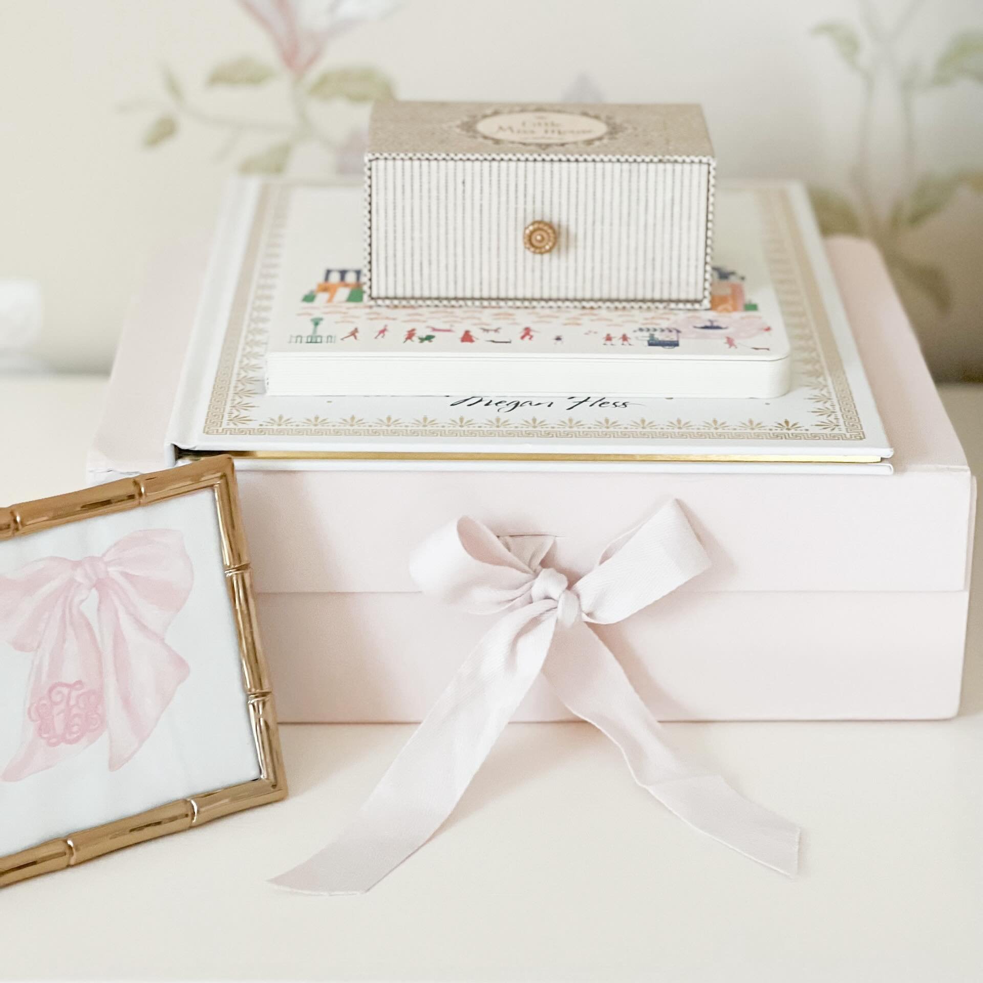 All in the details🎀 My sister-in-law painted this bow and monogram for Grace&rsquo;s baby shower invitation. She surprised me with the framed original at the shower to keep. It&rsquo;s one of my favorite things in her nursery! 🥹💕
.
.
. 
#grandmill