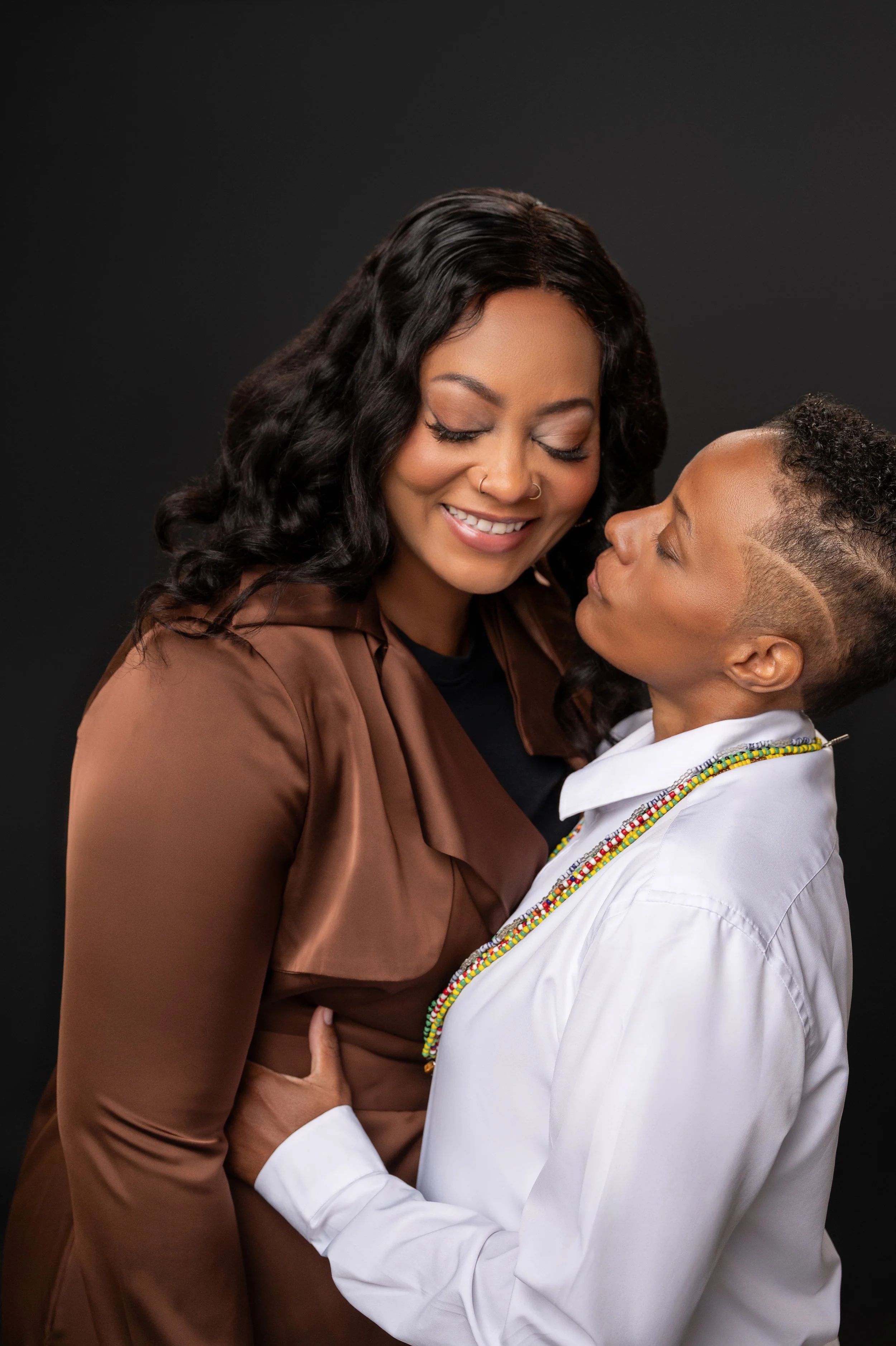 Two women in love share a moment in a photography studio 