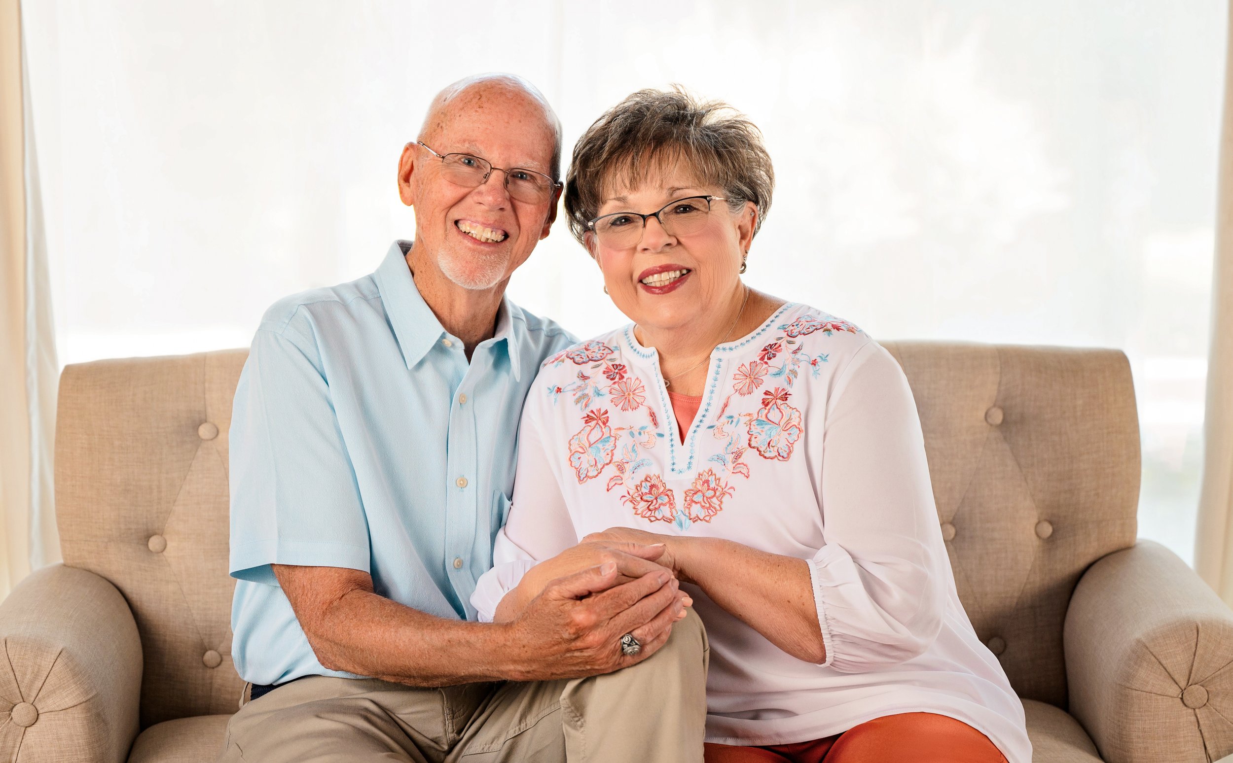A senior couple smile for their anniversary photos 