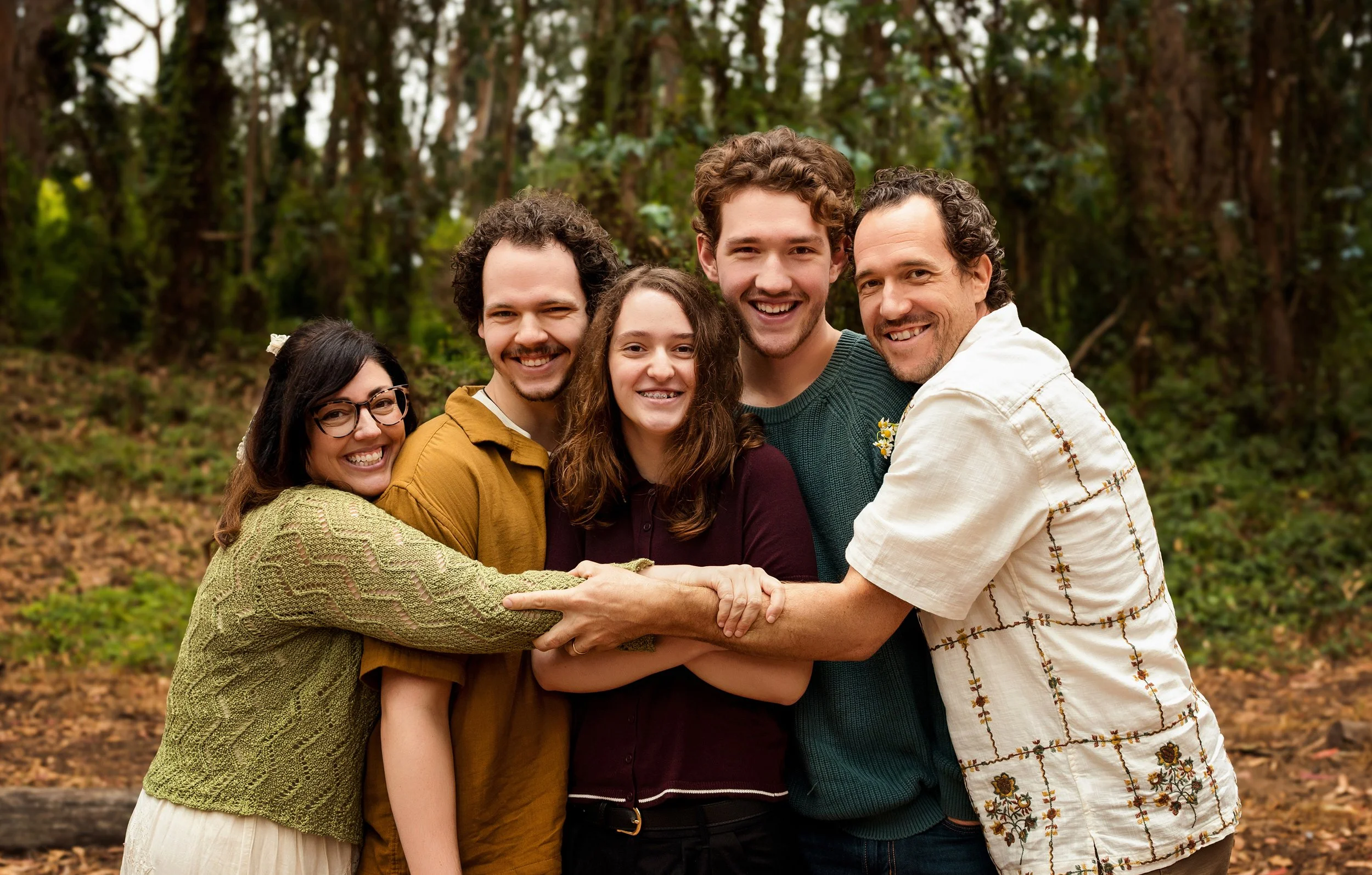 The Lemaire Family hold each other in Golden Gate Park