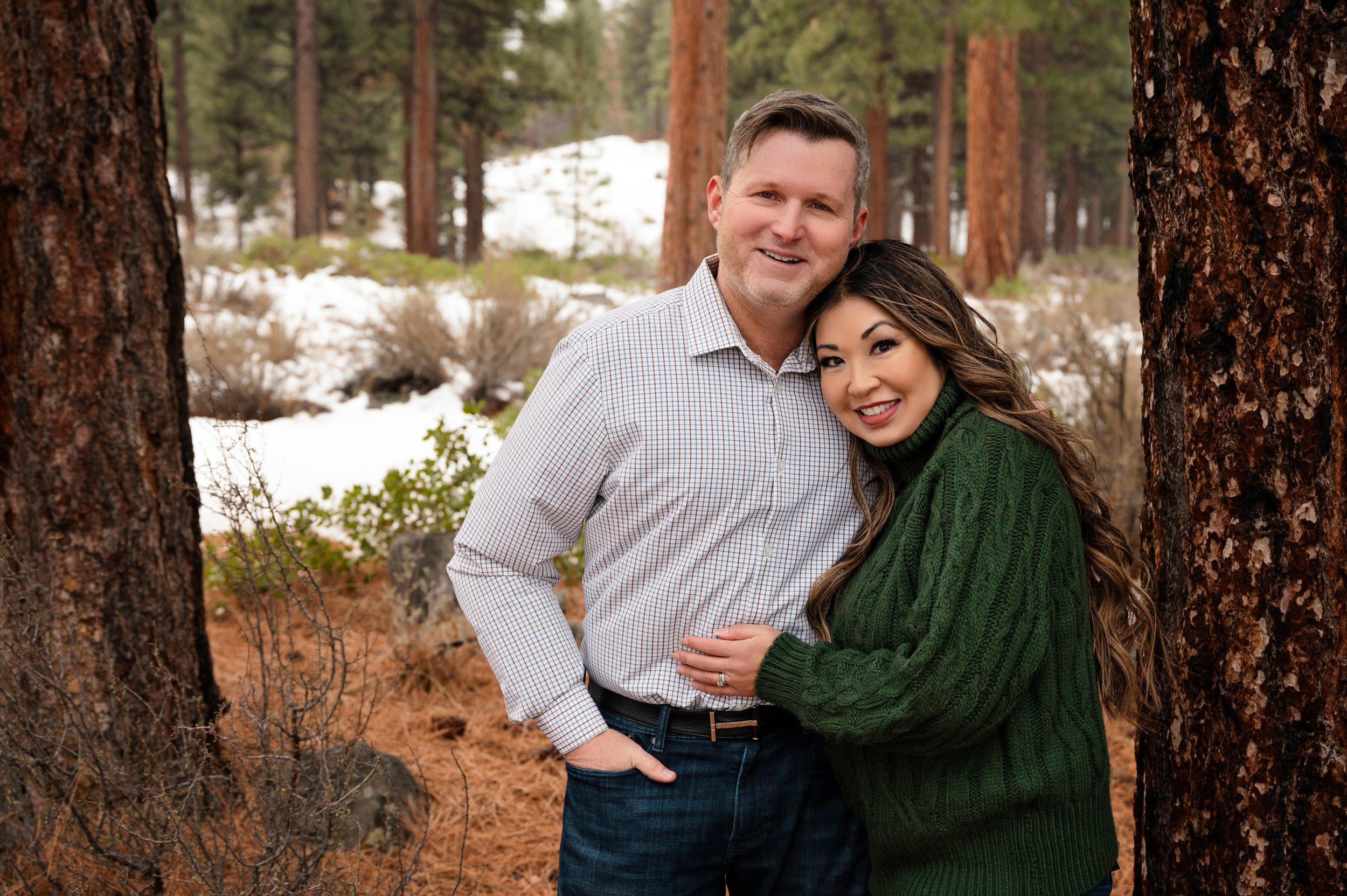 A professional couple smile in the Galena Tahoe Forest