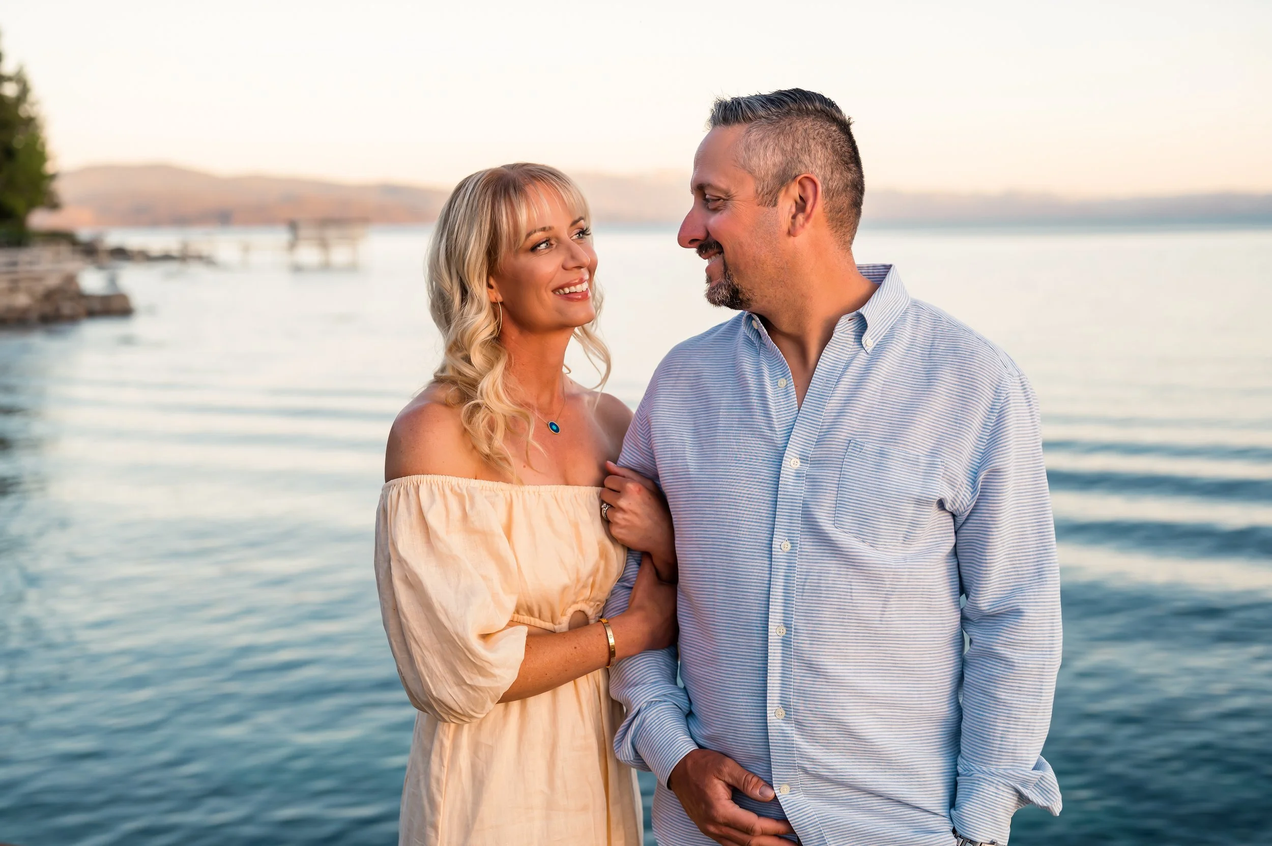 A beautiful couple smile at each other in Lake Tahoe Nevada with Lemaire Photography 