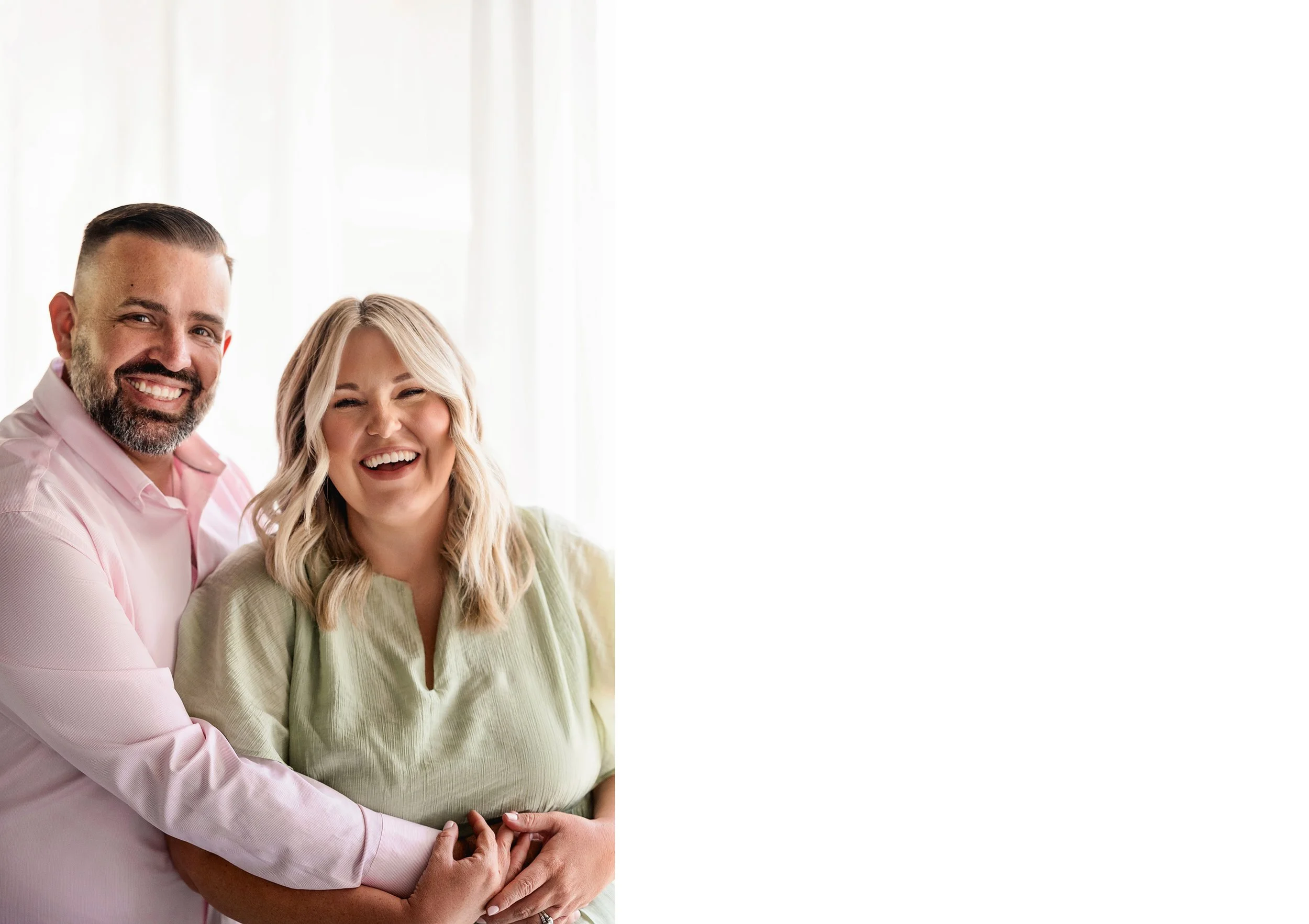 A happy couple smile for Lemaire Photography in their studio