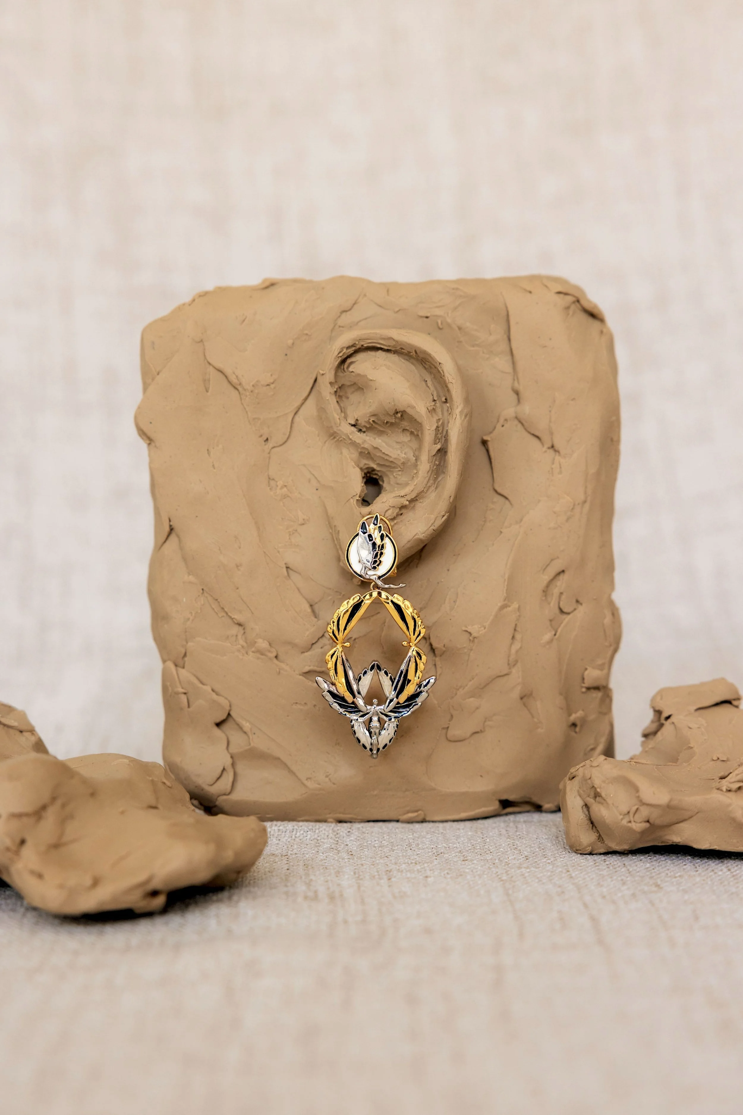 Soaring earring gold black 2T on ear.jpg