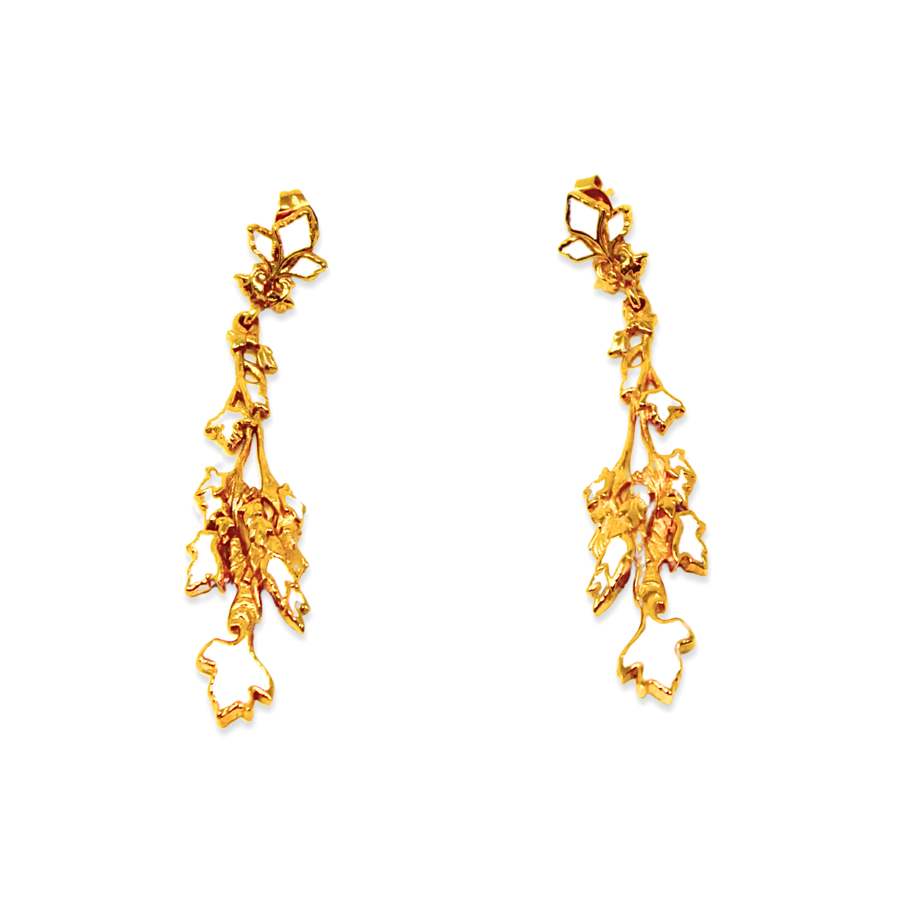 Gold earrings with a leaf and vine design, with bright white enamel accents.