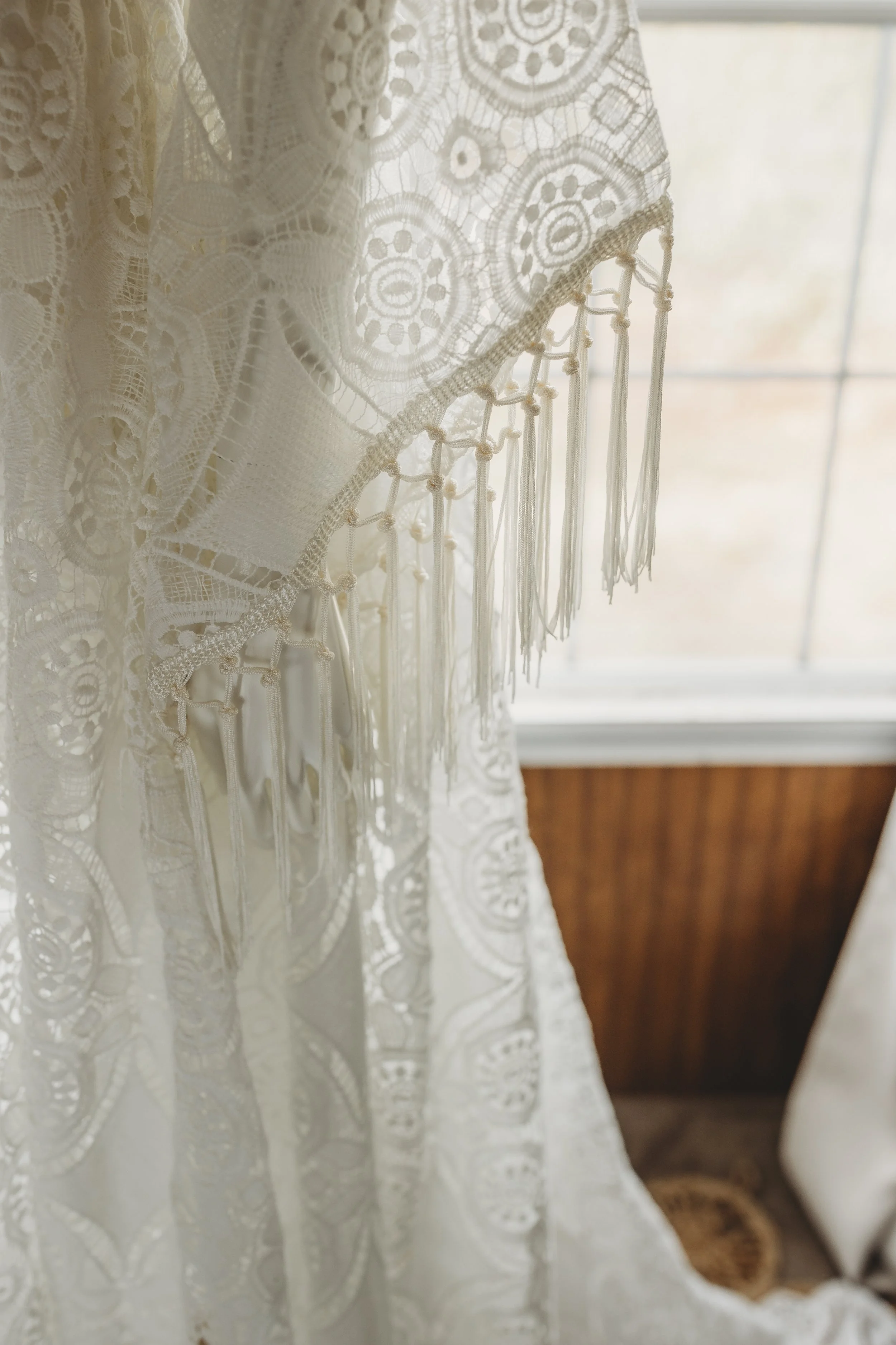 Ivory lace sleeve detail with delicate fringe trim on a bohemian maxi dress.