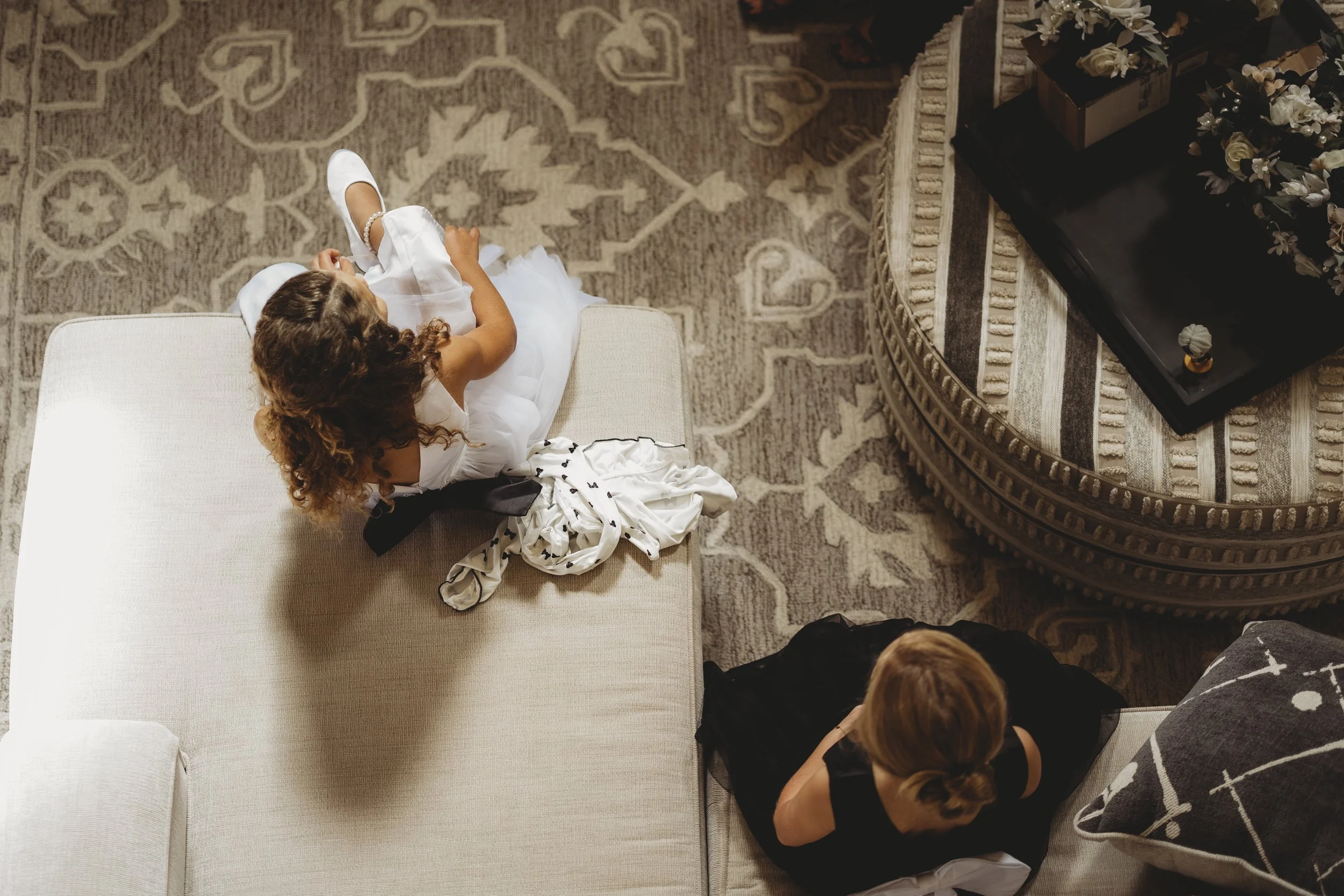 A tender moment from above, capturing the closeness of children and the calm of love growing in between.