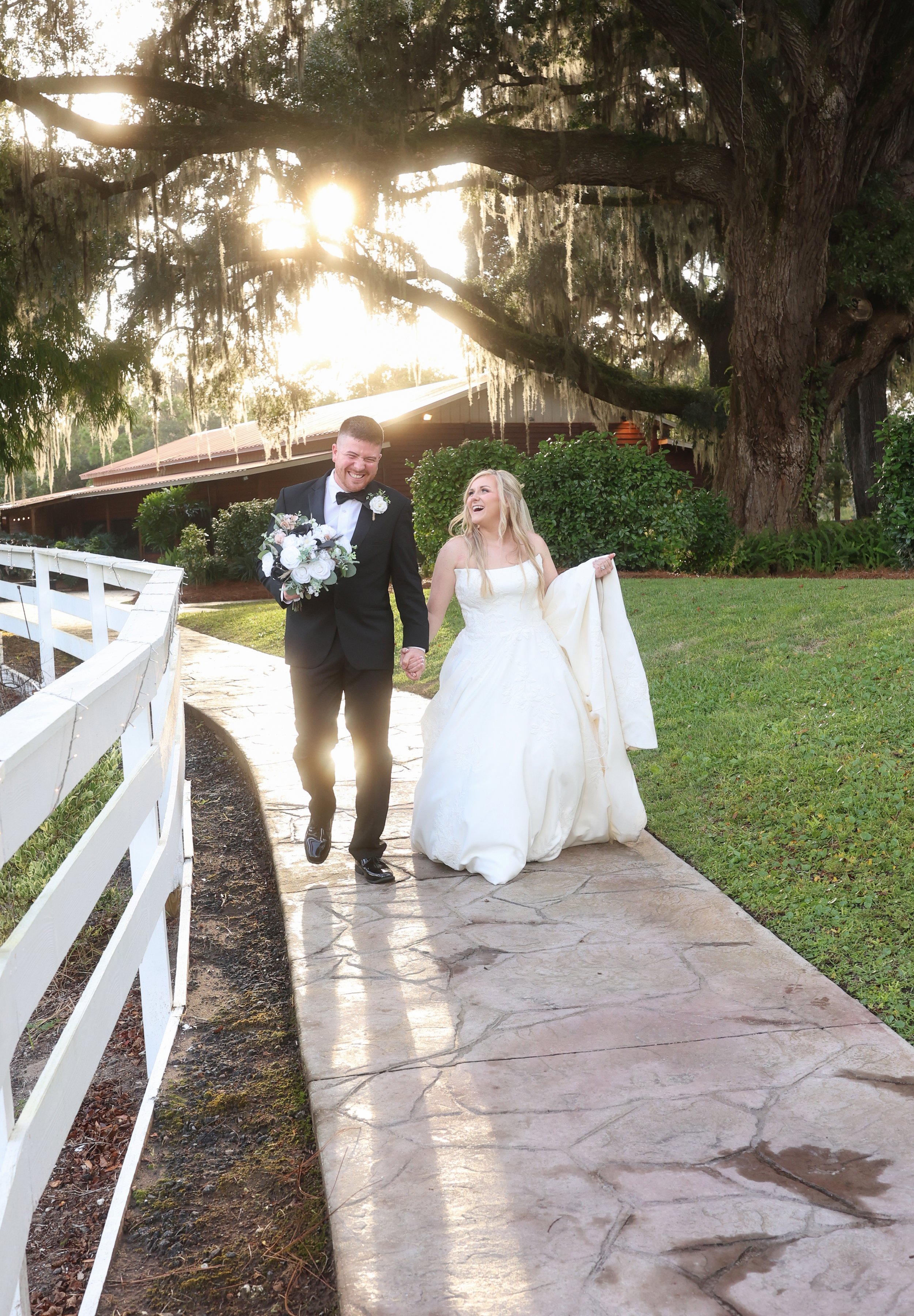 Newly married, they walk side by side in golden light, smiles wide and hearts already ahead of them.