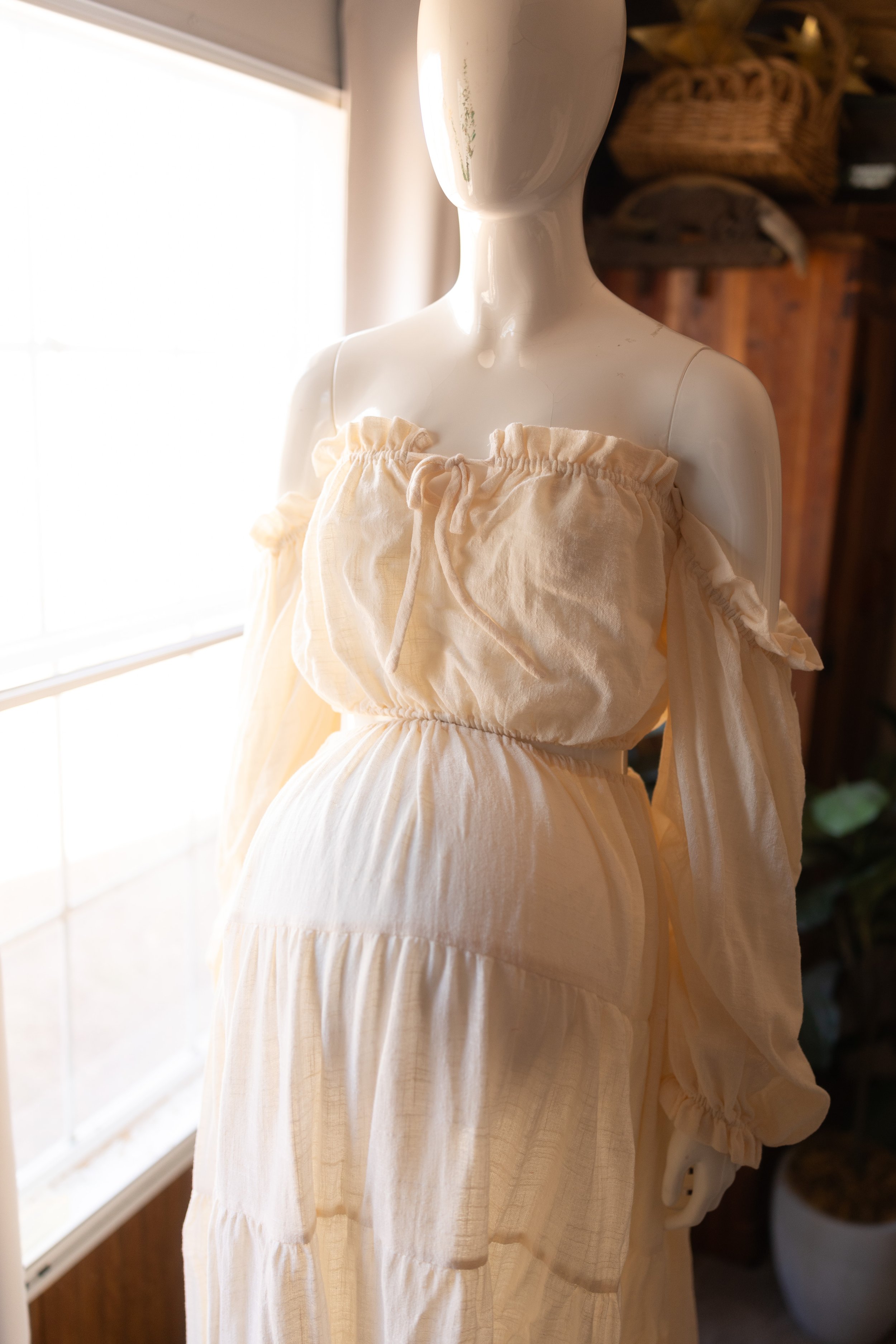 Versatile maternity dress with adjustable elastic waist, shown worn both over and below the belly in natural light.