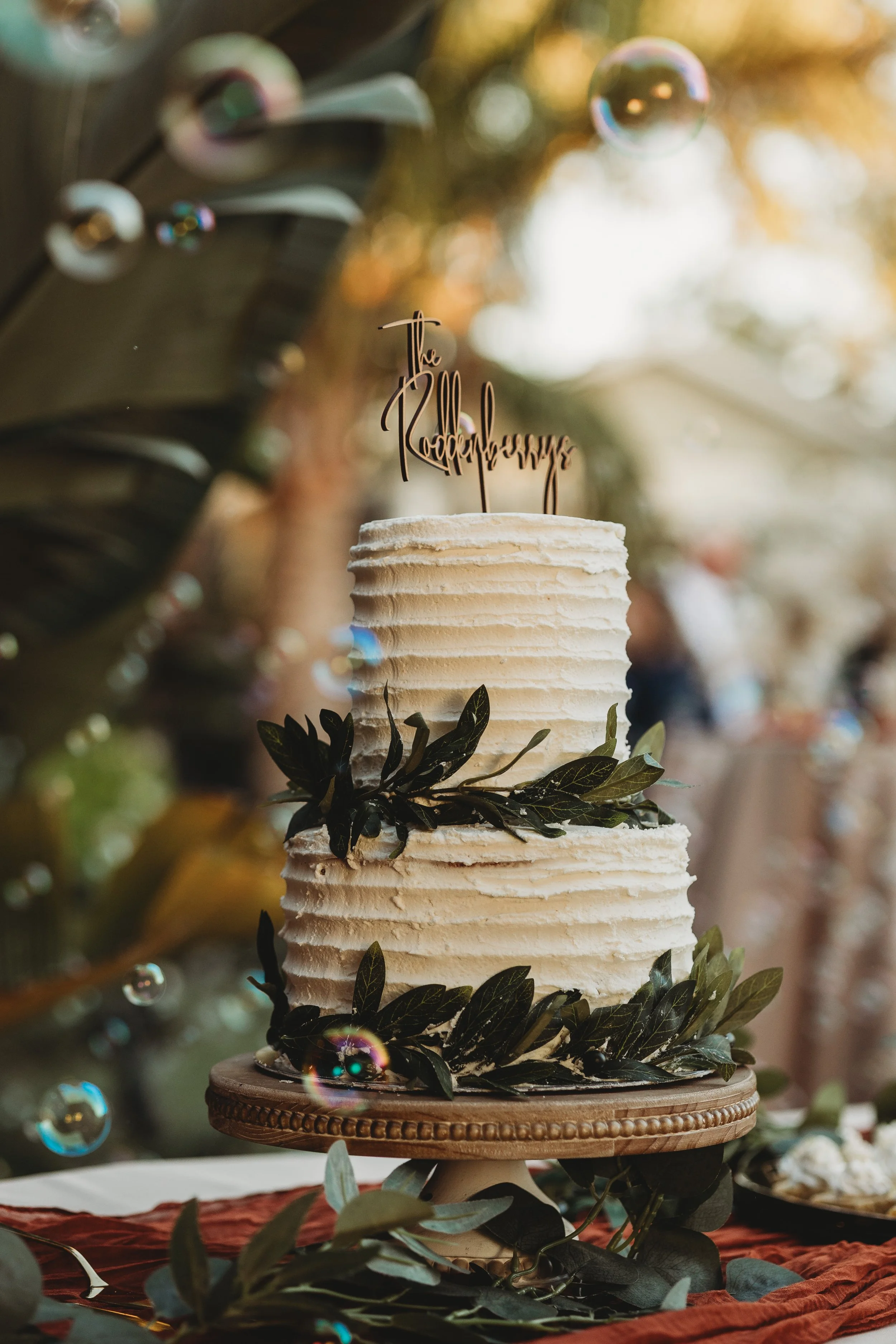 Close-up of a wedding cake with leafy details and bubbles