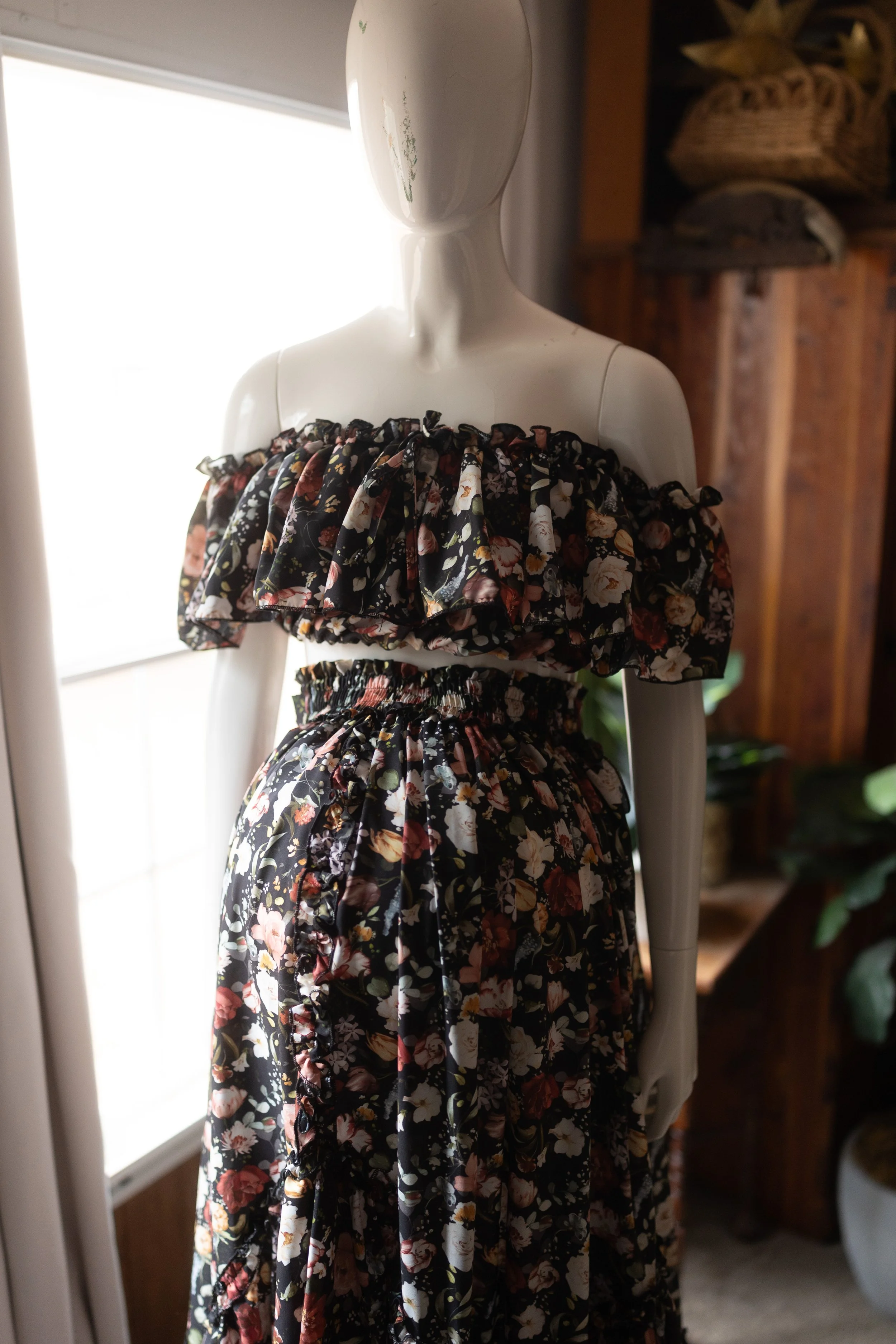 Dark boho floral dress with off-the-shoulder neckline and elastic waist, styled over the bump.