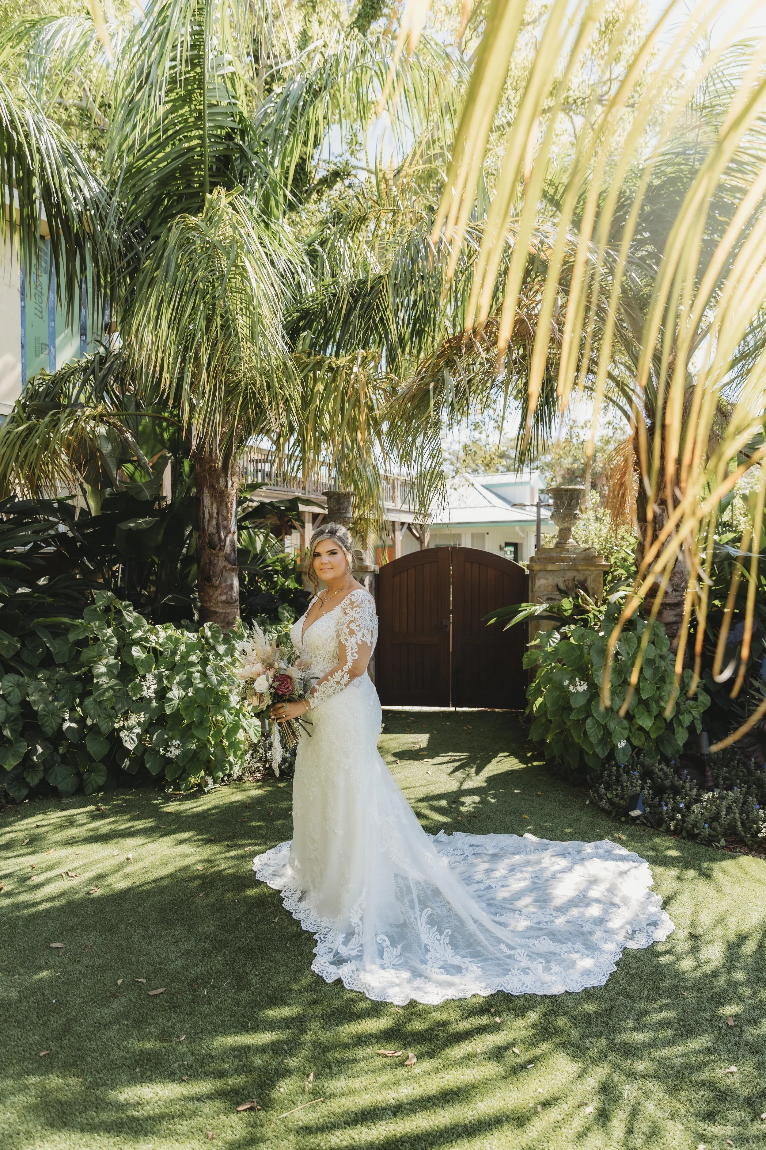 Full-length portrait of the bride standing in natural light.