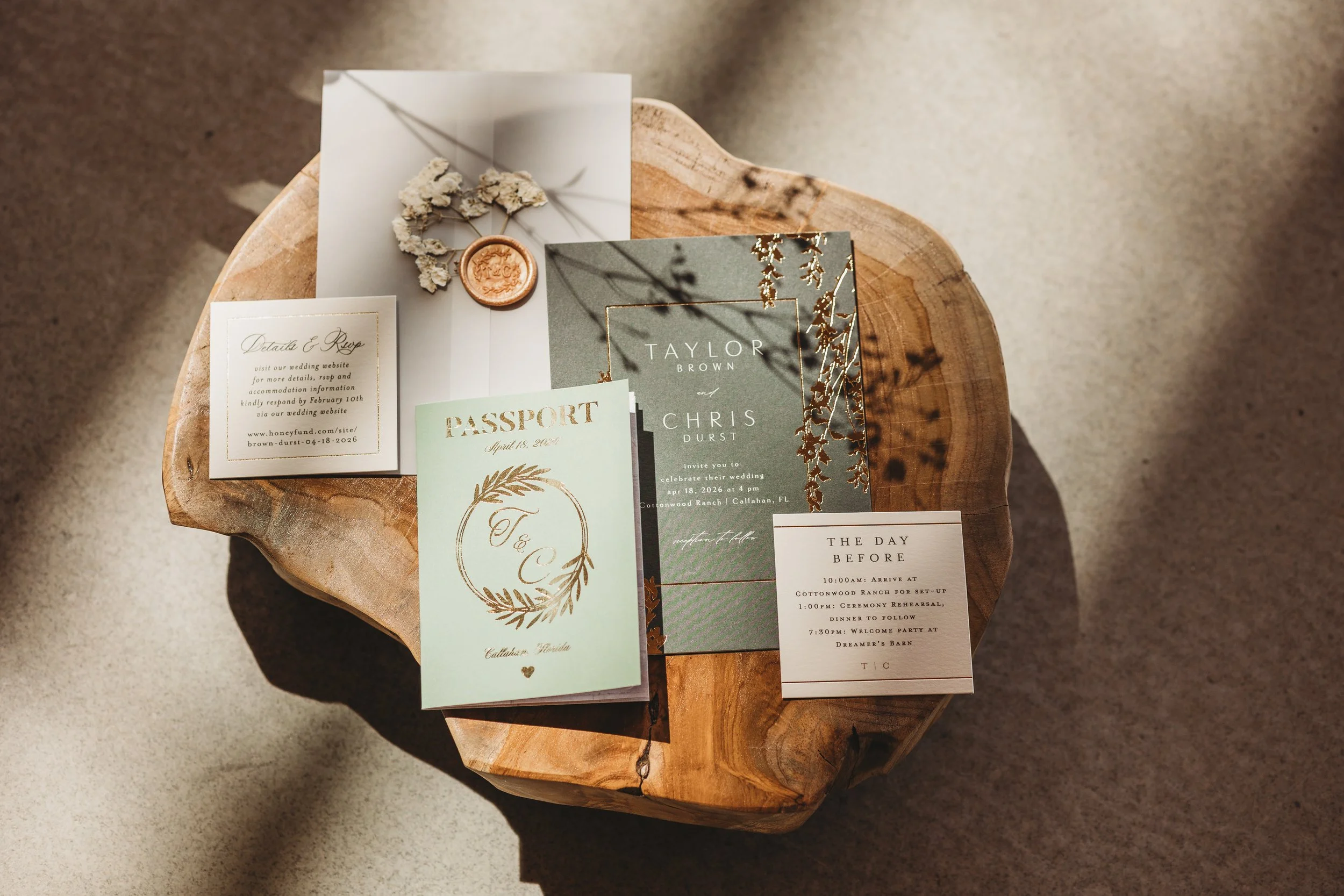 Wedding invitation suite displayed with elegant stationery on a rustic wooden table.