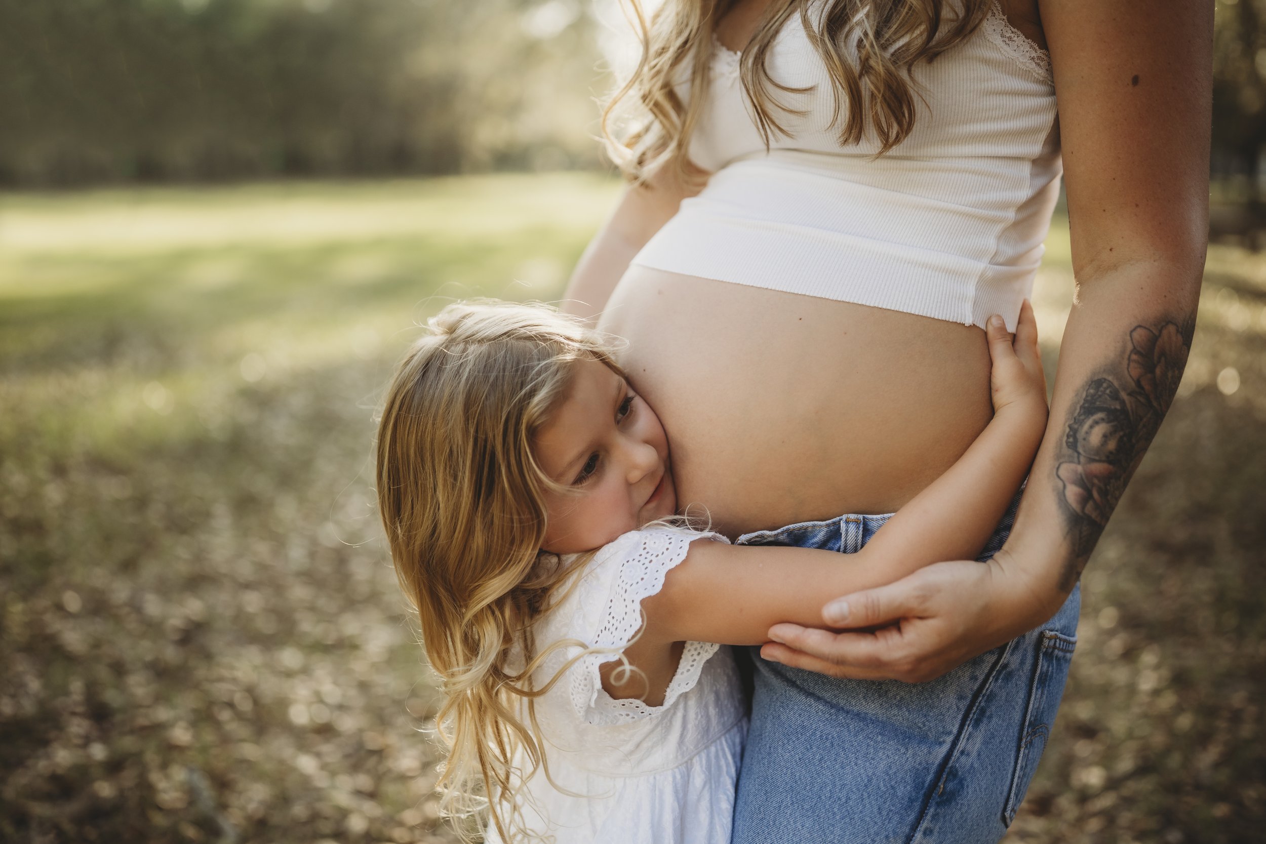 Before the baby arrives, love is already wrapped around them—held by a sister and a mother in one quiet moment.