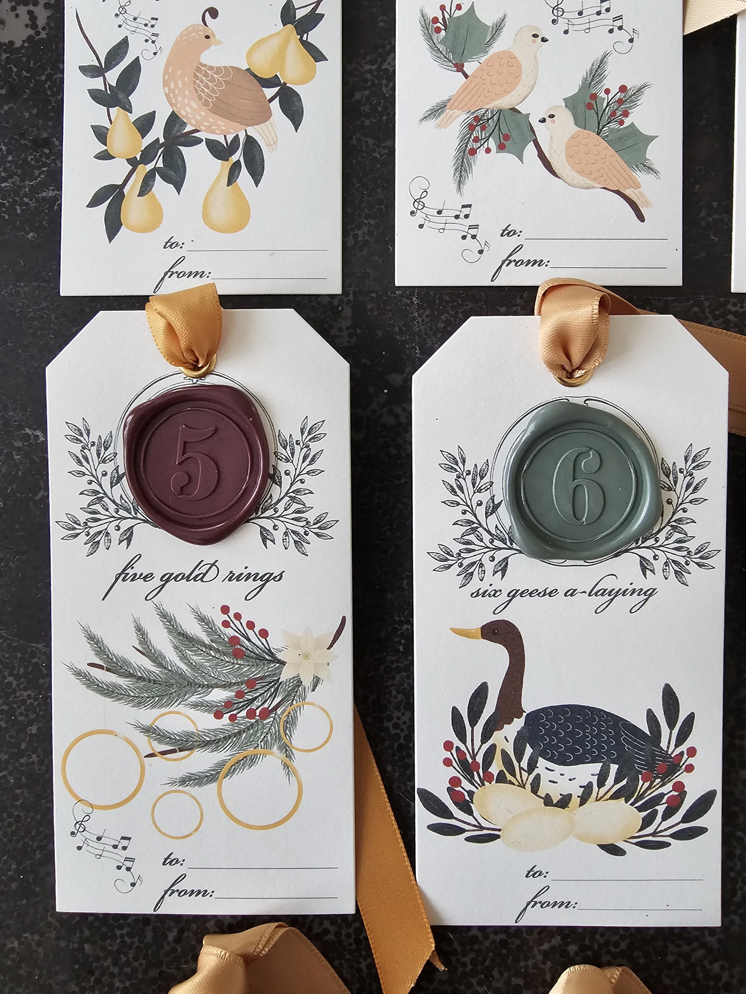 Heirloom-style holiday tags with wax seals and folkloric illustrations inspired by 12 Days of Christmas.