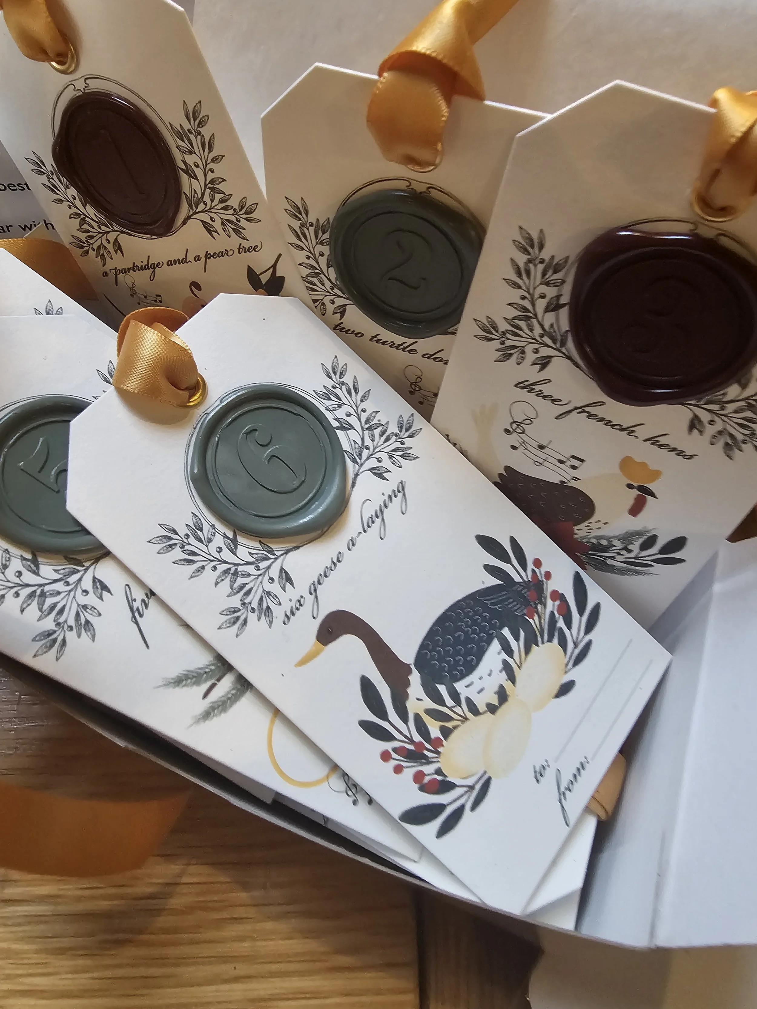 Numbered wax seal gift tags for 12 Days of Christmas countdown gifts and holiday scavenger hunts.