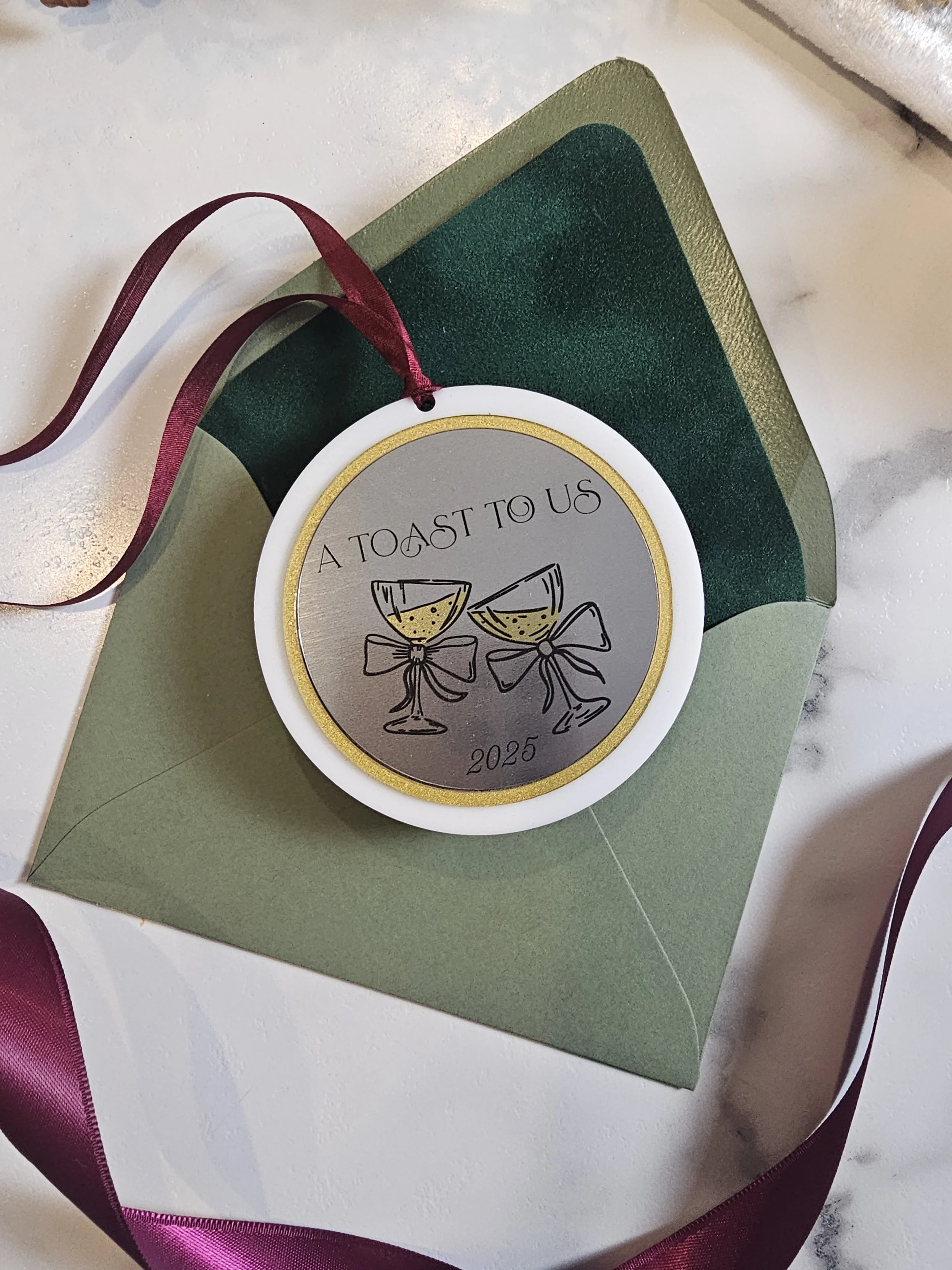 Romantic holiday ornament featuring champagne toast illustration and gold border