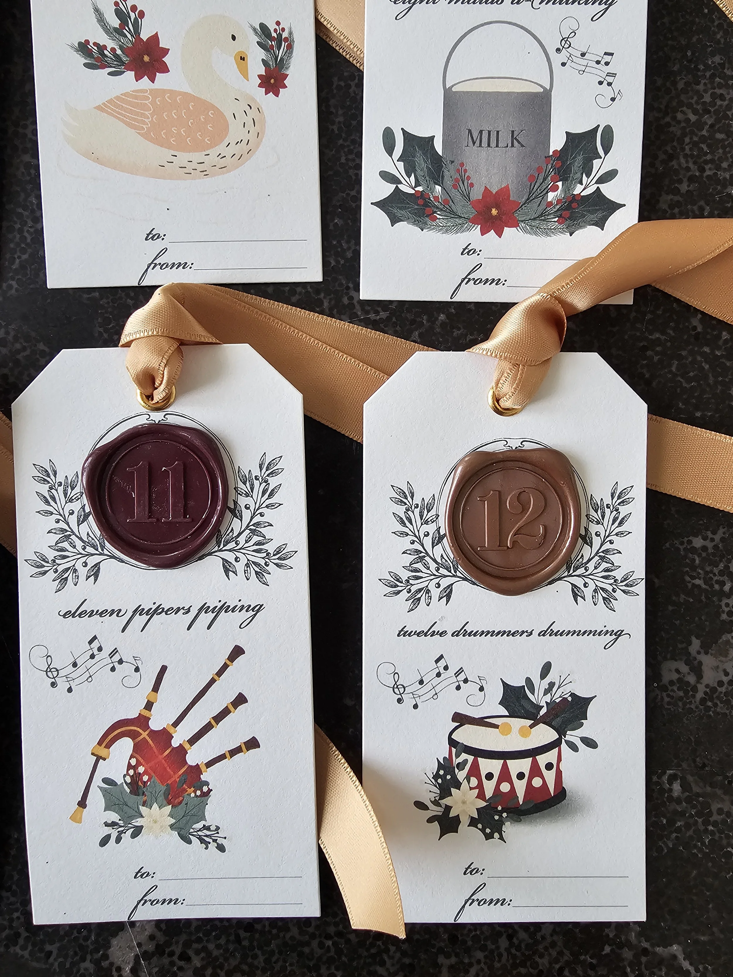 Wax-sealed Christmas tag featuring illustrations and satin ribbon for holiday gift wrapping.