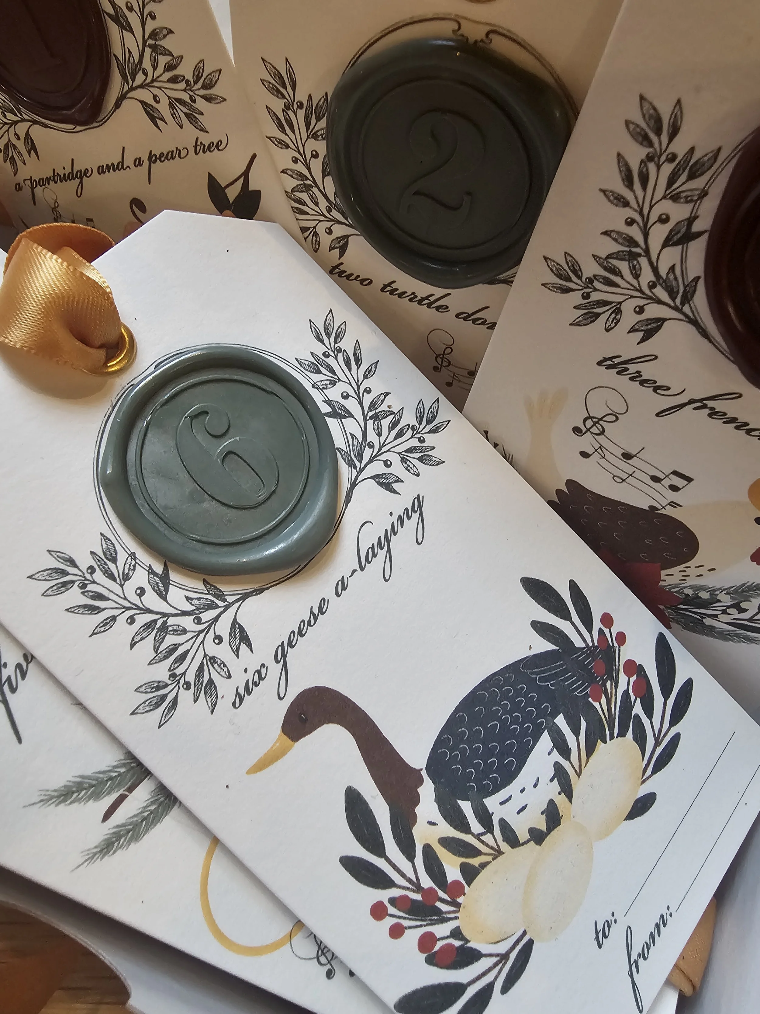 Wax-sealed Christmas tag featuring illustrated goose and satin ribbon for holiday gift wrapping.