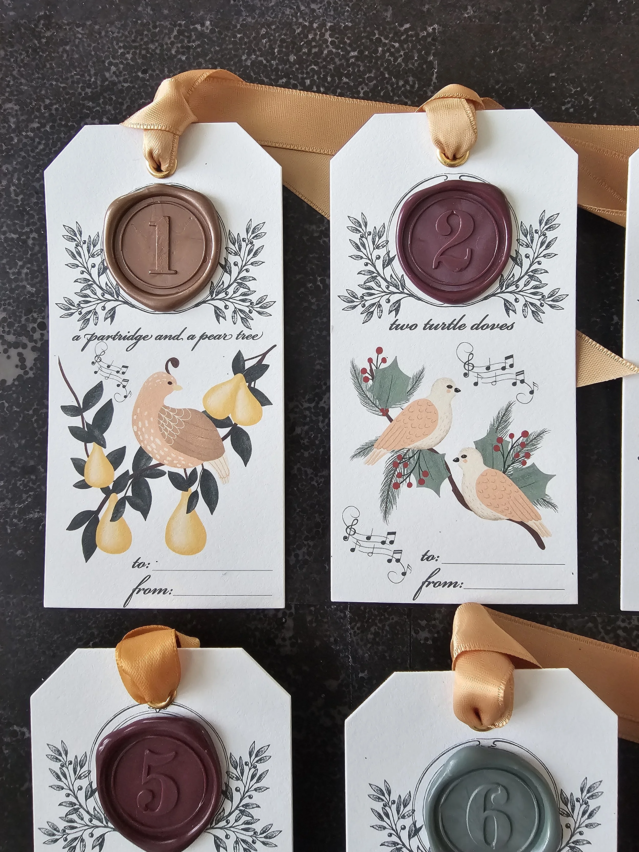 Illustrated 12 Days of Christmas tags with wax seals and festive artwork for luxury holiday packaging.