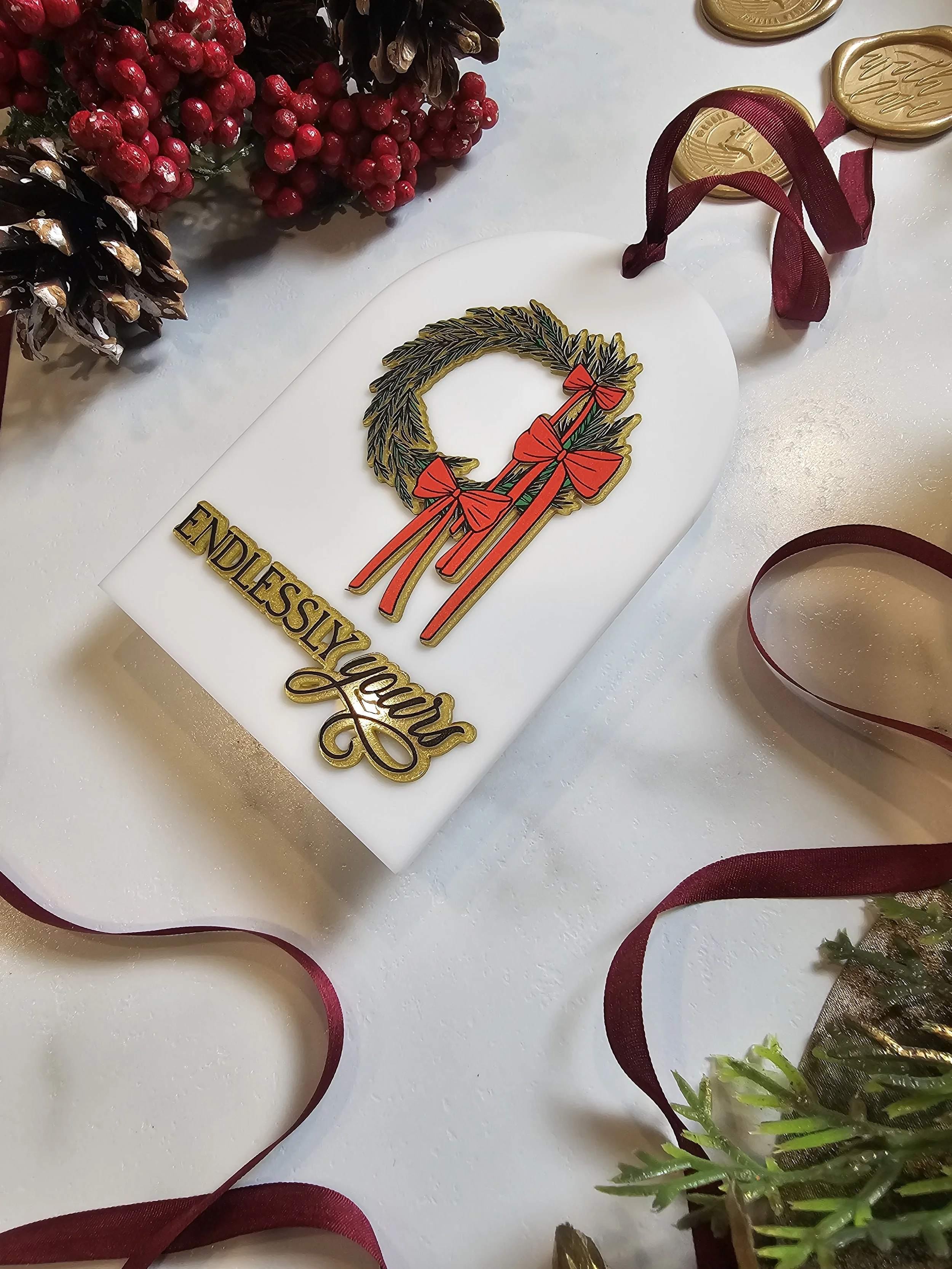 Wreath ornament shown next to velvet lined envelope from 12 Days of Us collection