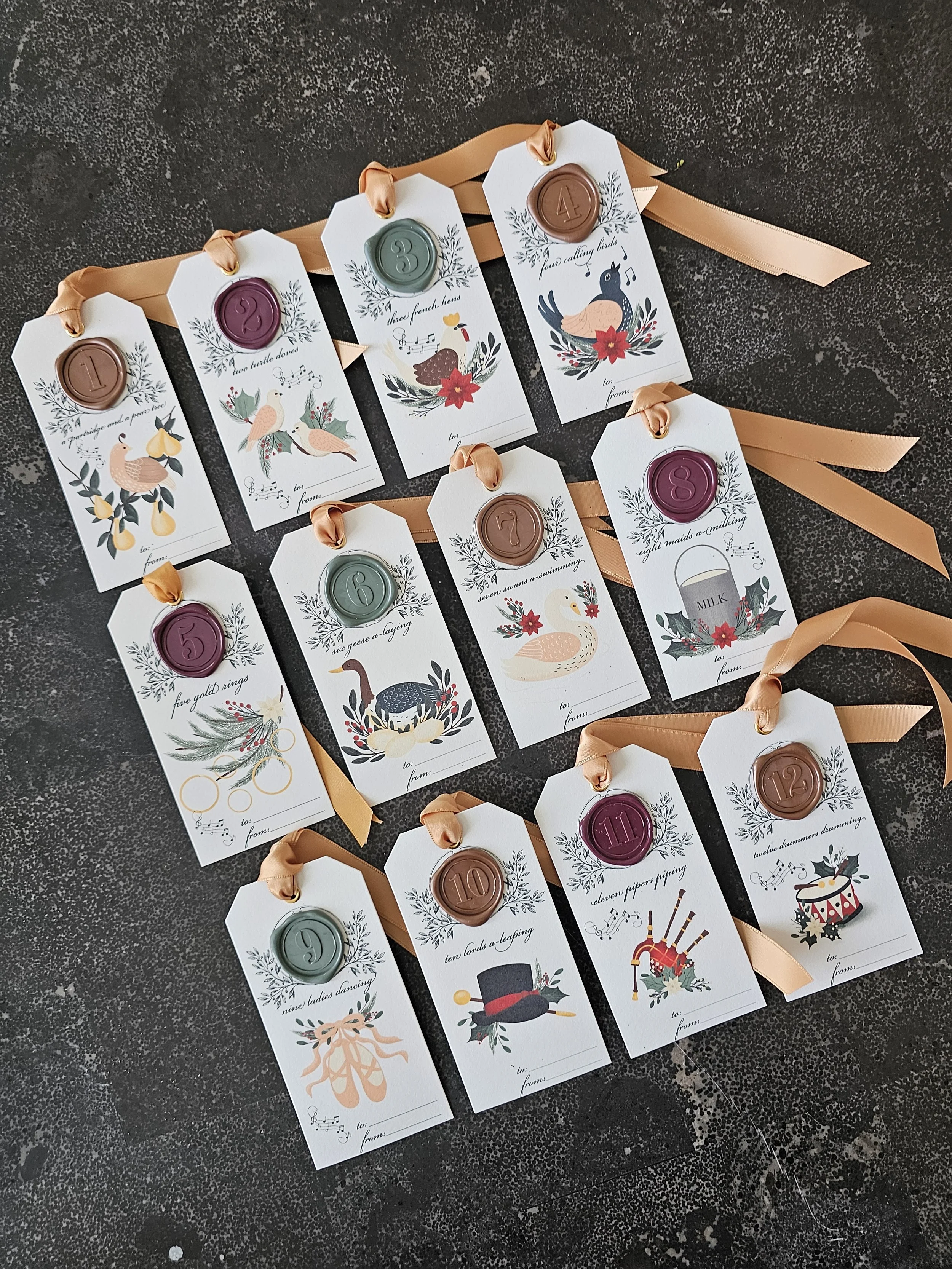Set of twelve 12 Days of Christmas gift tags with wax seals and satin ribbon by RBW Stationery.