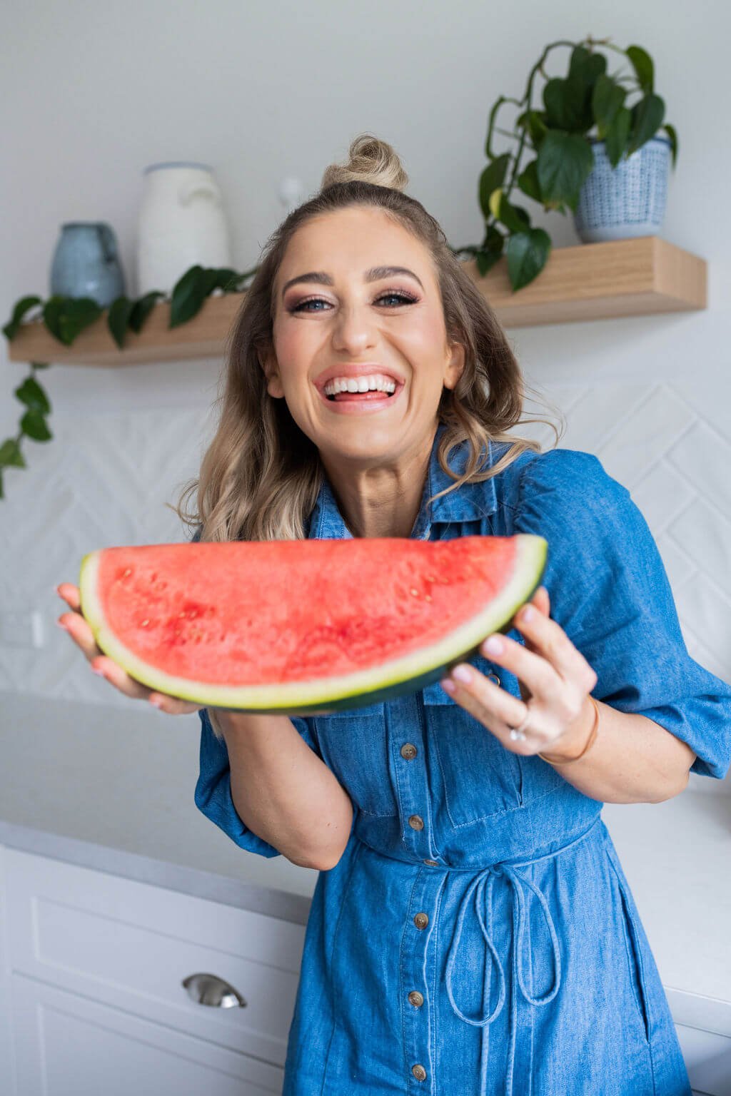 Lucinda with watermelon in kitchen