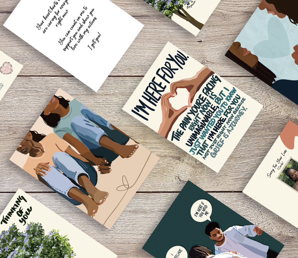 Various cards with inspirational messages and illustrations laid out on a wooden surface.