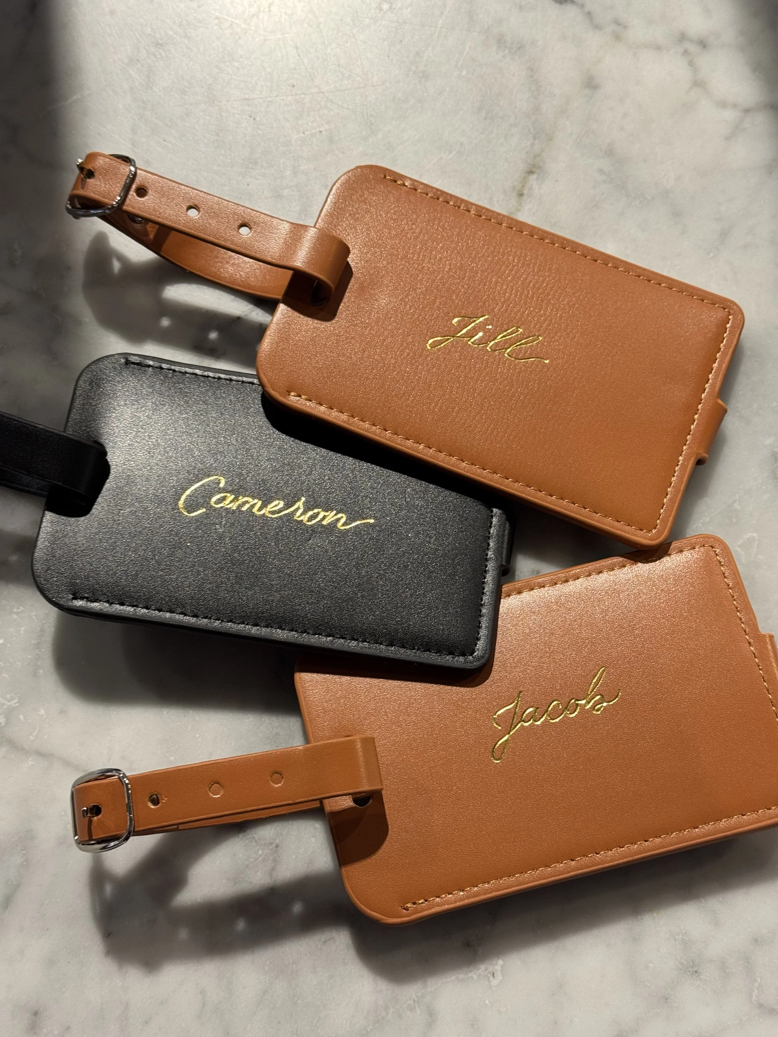 Gold foiled luggage tag, luxury luggage tag experiential activation; luggage tag conference personalization