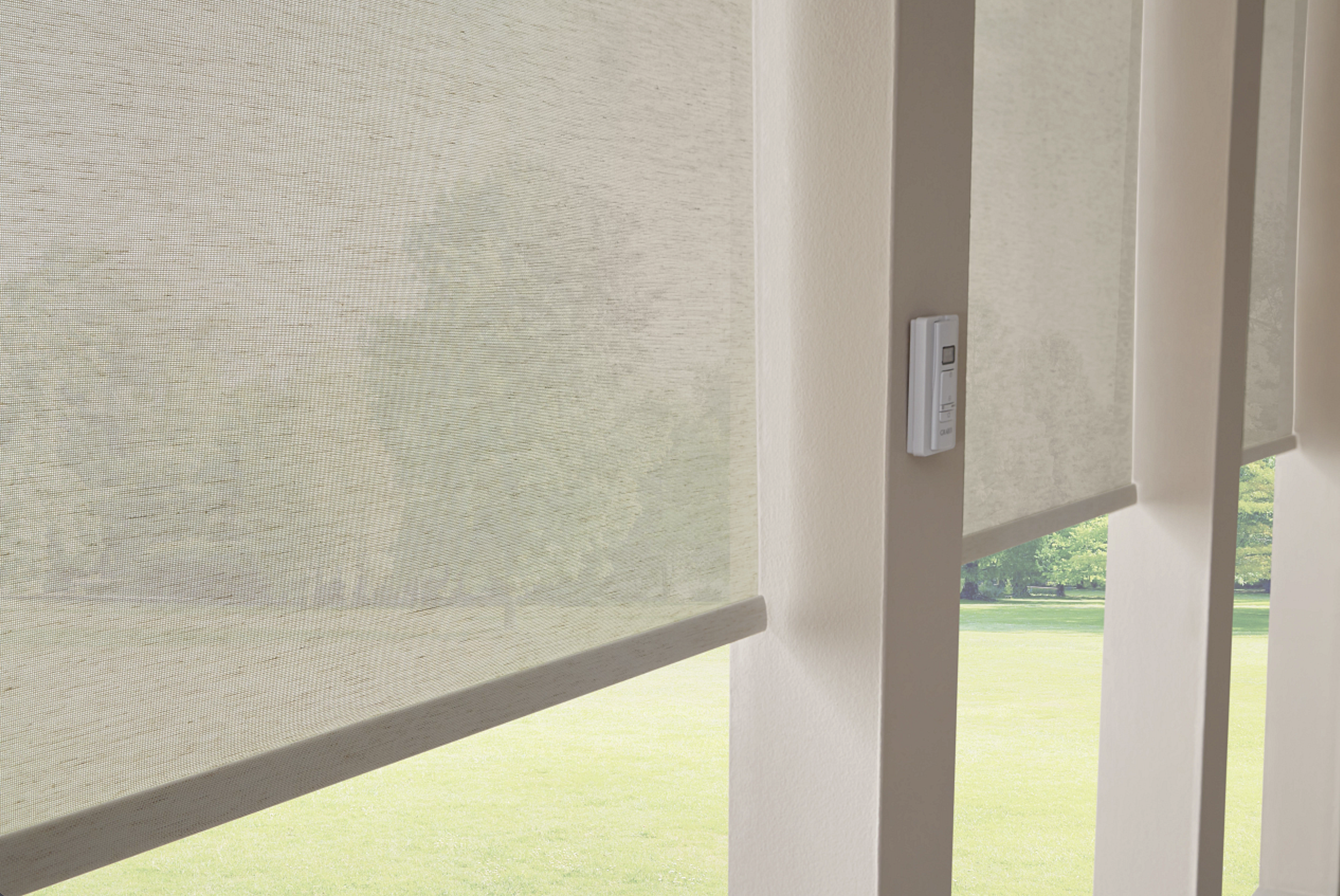 Light-filtering solar roller shades with remote control, allowing natural light while reducing glare and heat