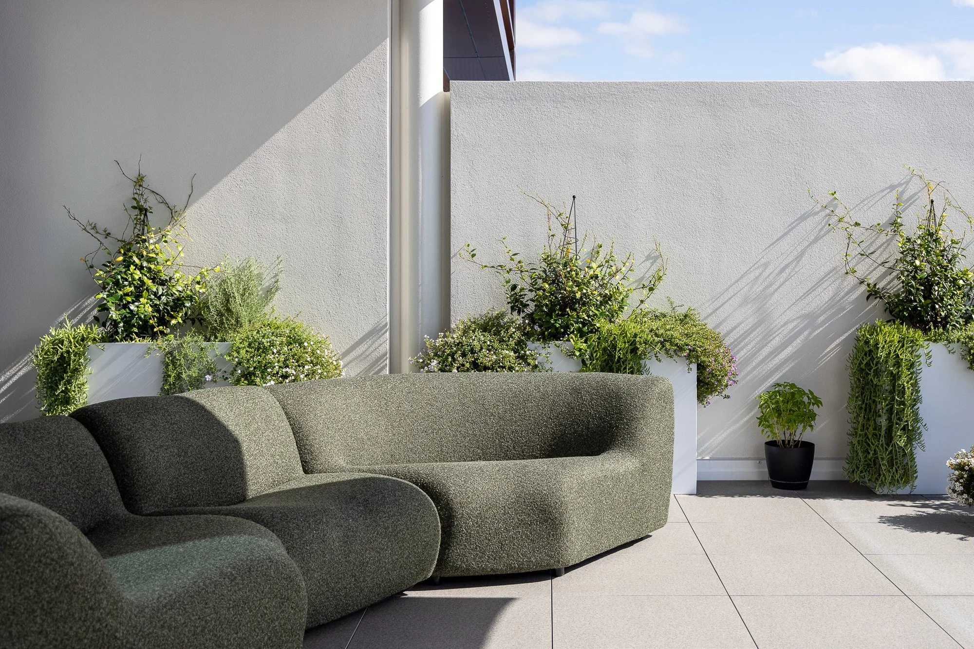 Balcony with outdoor lounge and greenery