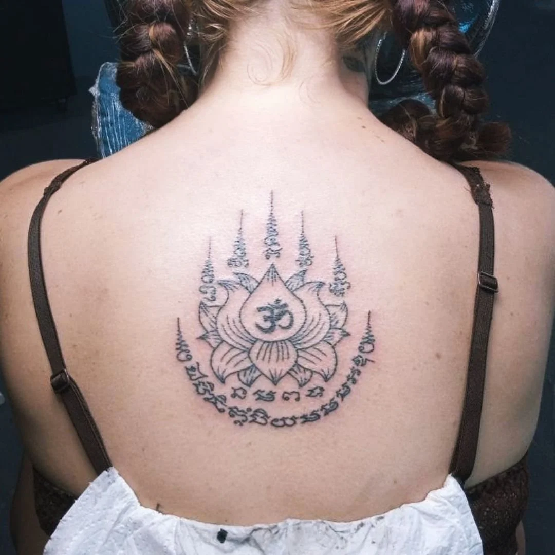 A Lady with a bamboo sak yant of a lotus flower