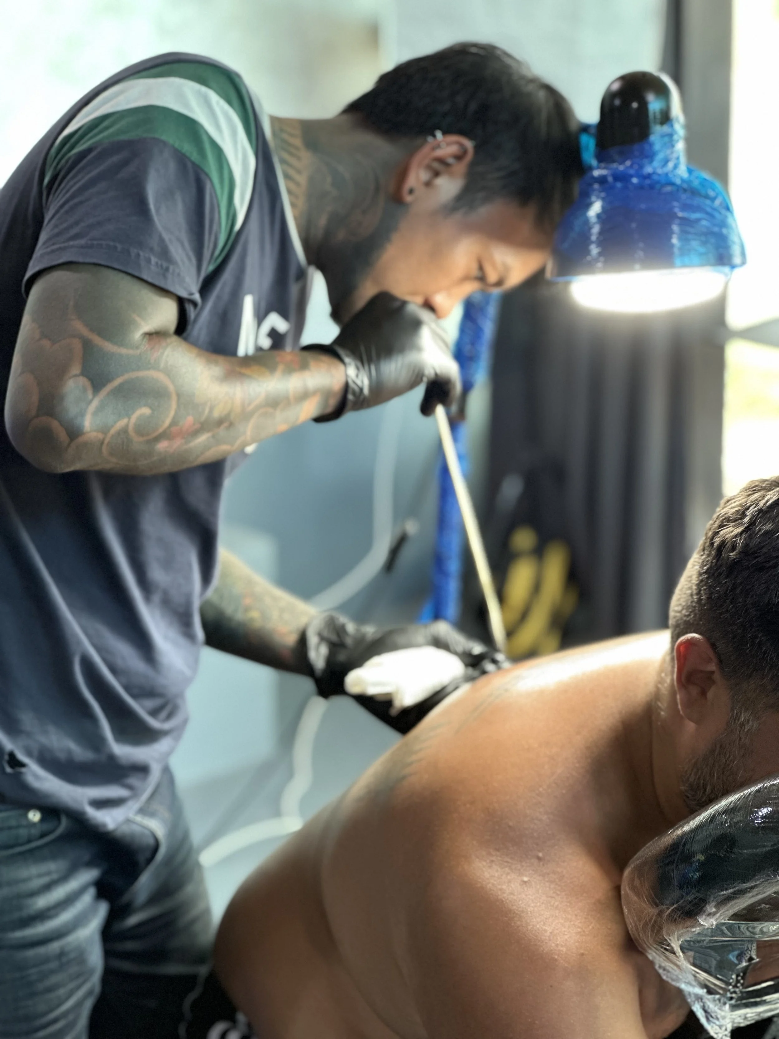 Traditional bamboo hand poked tattoo beiong applied at fighters ink in Karon, phuket