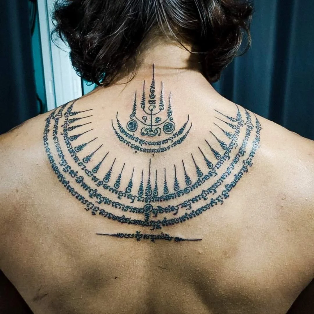 A man with a large bamboo tattoo on his upper back