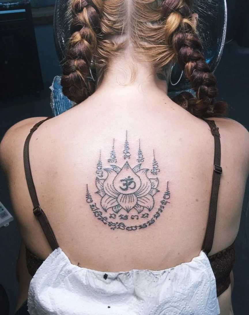 Lady with a lotus flower sak yant in phuket