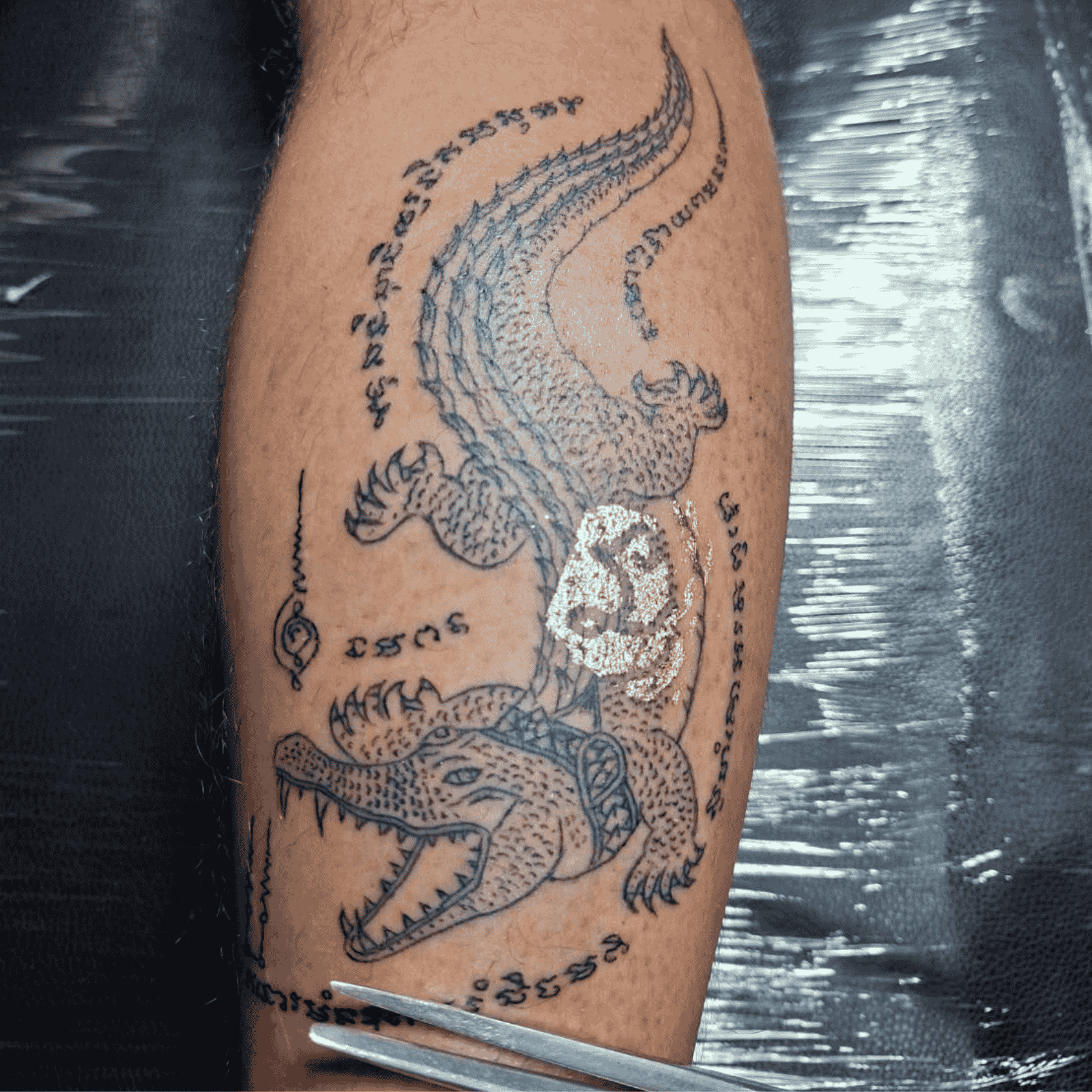 A man with a crocodile bamboo tattoo