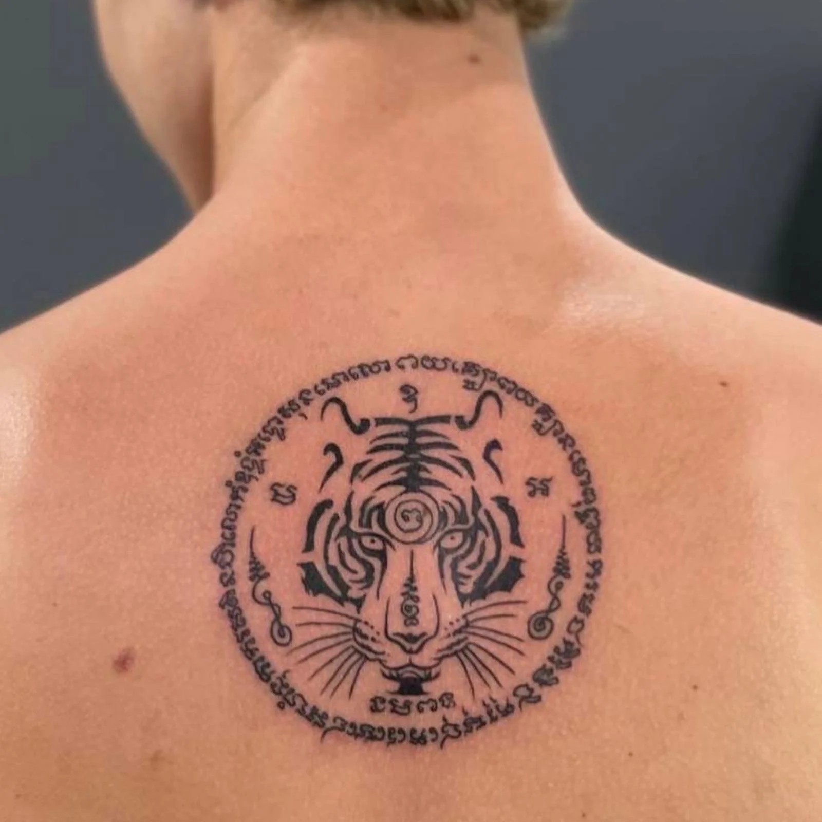 A man with a single face tiger sak yant