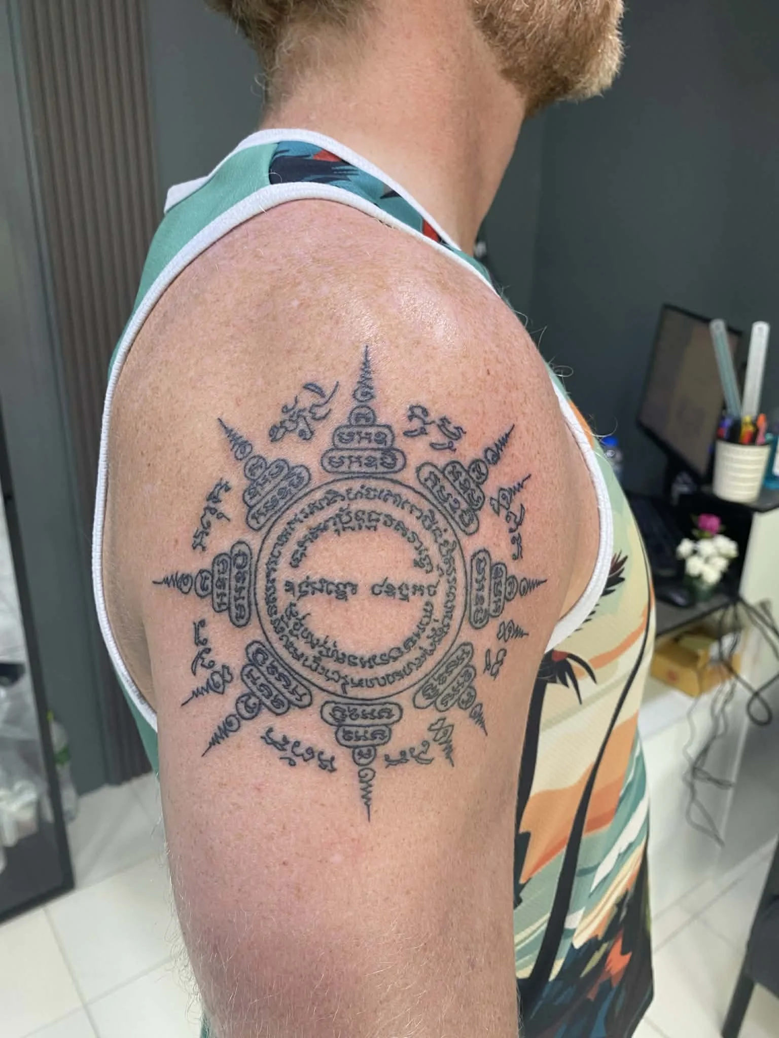 A man with a sak yant tattoo on his shoulder called the pied tidt