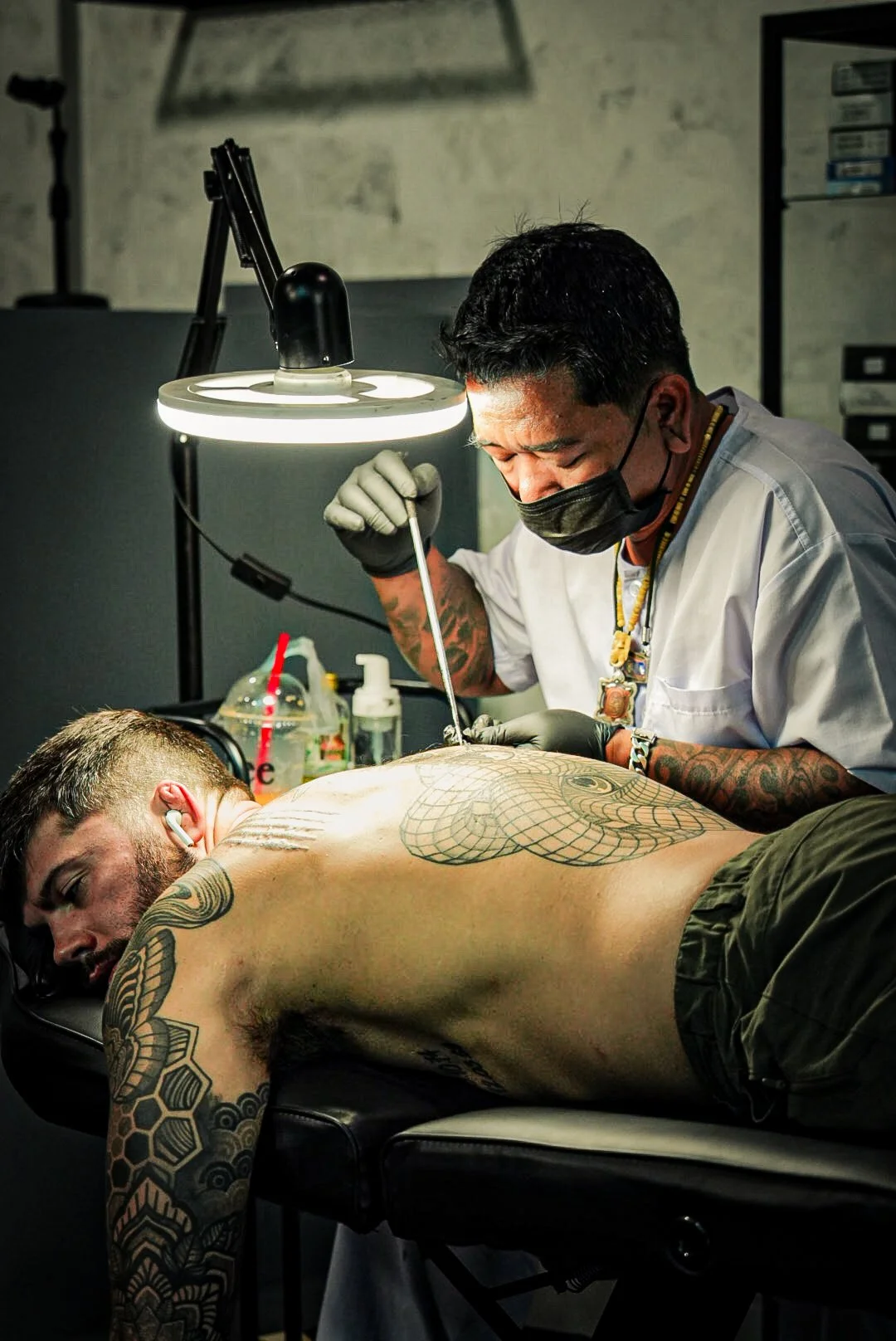Ajam Dam giving a bamboo tattoo in phuket