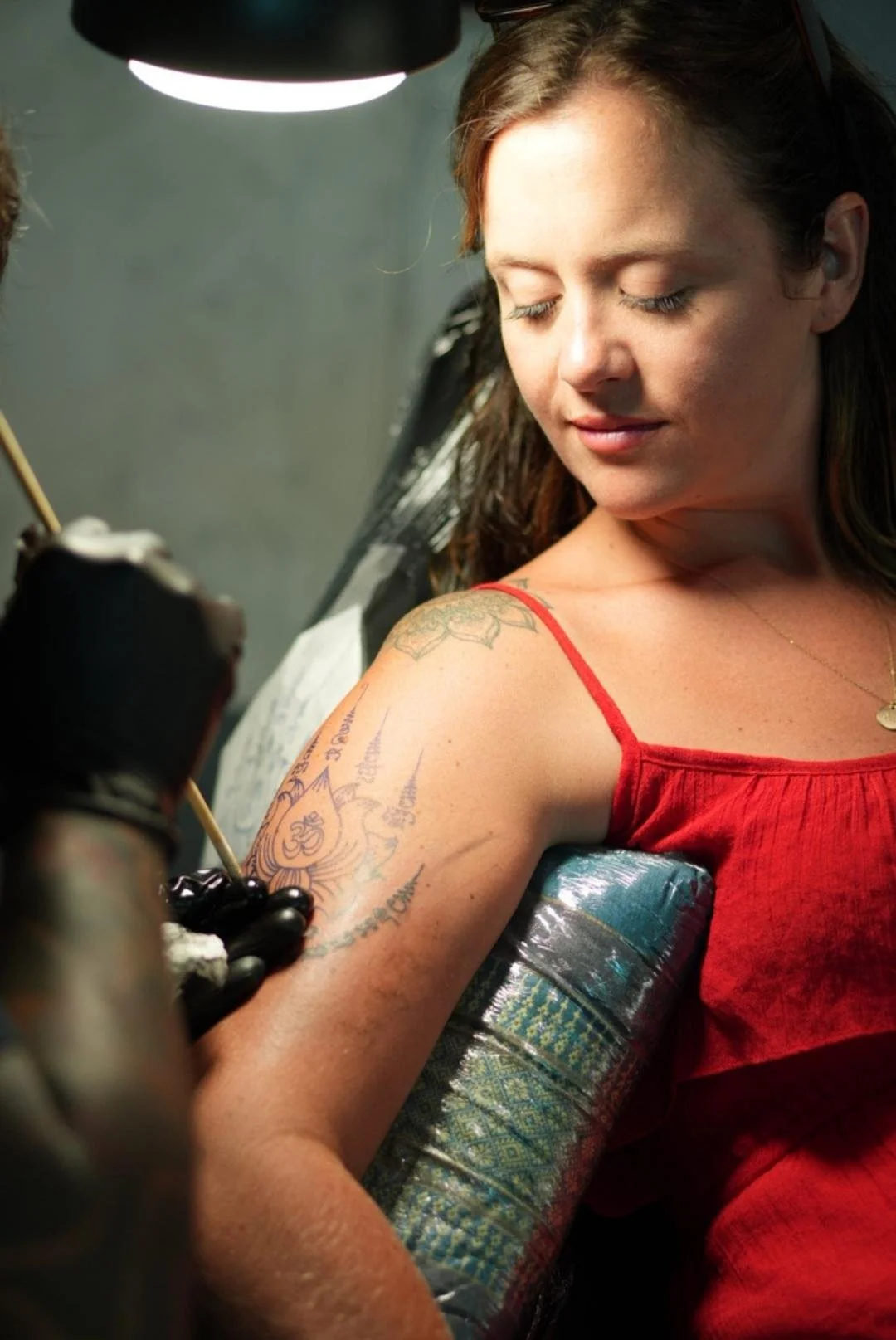 Traditional hand-poked Sak Yant arm tattoo session in Phuket with sterile medical hygiene