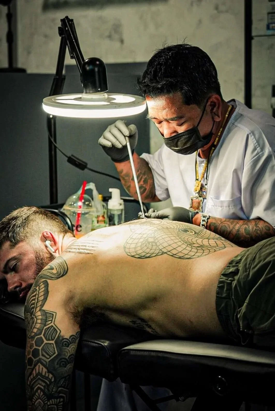 Tattoo master performing authentic bamboo tattoo and Sak Yant Phuket session